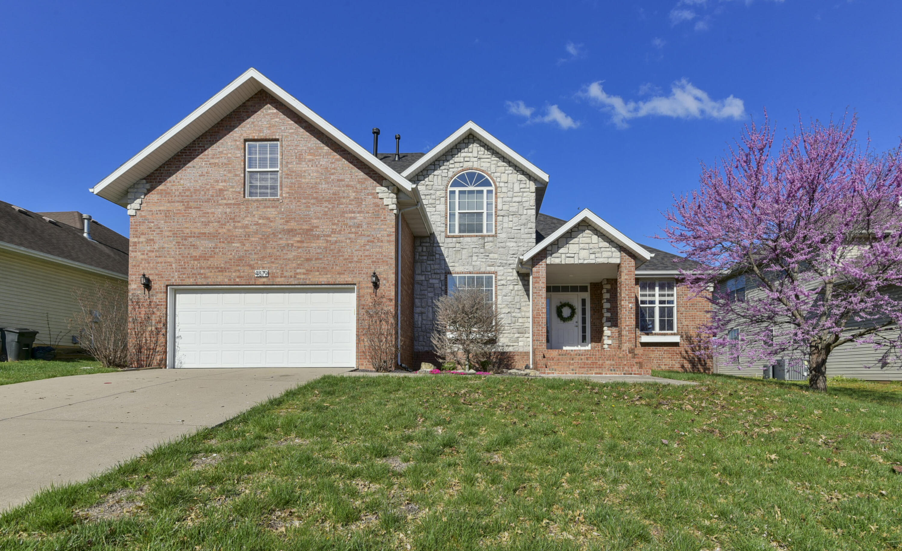 You'll love this 4 bedroom, 2.5 bath home in Battlefield that features two living areas, high ceilings, gas fireplace, granite countertops, hardwood floors, a master suite on the main level, covered patio with a back yard that opens to Wilson's Creek Intermediate School Trail. All this and a nice, quiet location on a non-through street! Schedule your private showing today.