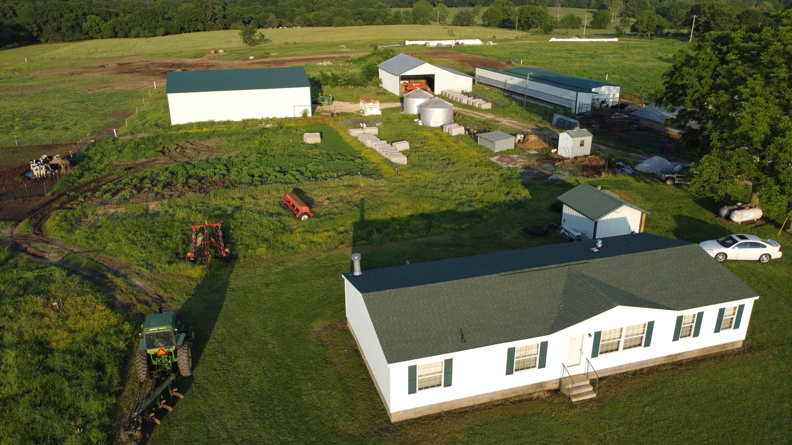 Proven efficiency over decades. This Well maintained 80 Acre Dairy Farm has a proven income record of up to $8,000 monthly with only an average of 33 cows milked as a one man operation. It is one of the most practical, flexible and labor-effective milking parlors available.Herringbone milking parlors combine advanced milking technology in conjunction with the lowest required maintenance due to it's robust construction. It ensures milkers can work in a stress-free environment with smooth cow traffic. Herringbone parlors offer optimum animal positioning which is important for easy access and good visibility of the udder during milking. Come check out the Best Farm on the Market, altogether with Hay barns, calving pins, grain bins, automatic waterers, this Farm has it All! Including a 2002, 3 bed 2 bath manufactured Ranch Style Home.