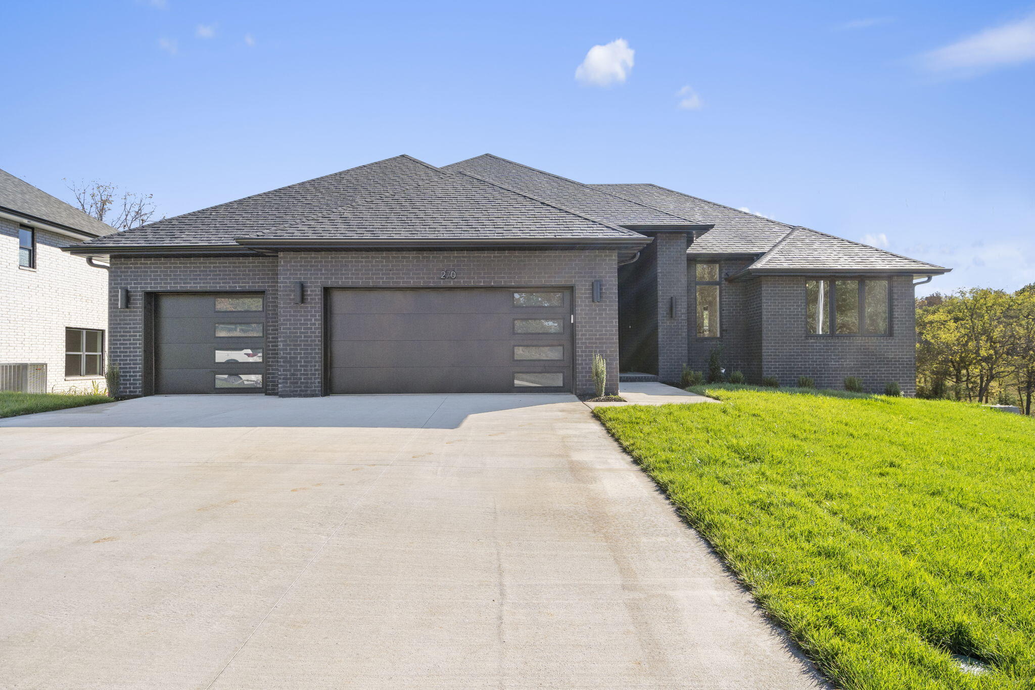 New gated subdivision on Springfield's East side with access to Hickory Hills Country Club! This stunning new construction home offers open layout, living room with tall ceilings, European White Oak hardwood flooring, a gas fireplace, and custom built-ins. Kitchen features a large center island with seating space, quartz counter tops, walk-in pantry and ample dining space. Split bedroom floor plan features a spacious master suite with dual sink vanity, quartz counter tops, walk-in shower and a huge walk-in closet with access to the laundry room and garage. Bedrooms 2 & 3 share a full hall bathroom. The walk out basement features the 2nd family room, a wet bar, bedrooms 4 and 5 with a full bathroom, and a massive John Deere room that is vented and has a window. Enjoy sunrise each morning on the covered back deck or the covered downstairs patio. Yard is complete with sod and an irrigation system. AT&T Fiber internet available.  Quick and easy access to Hwy 65!