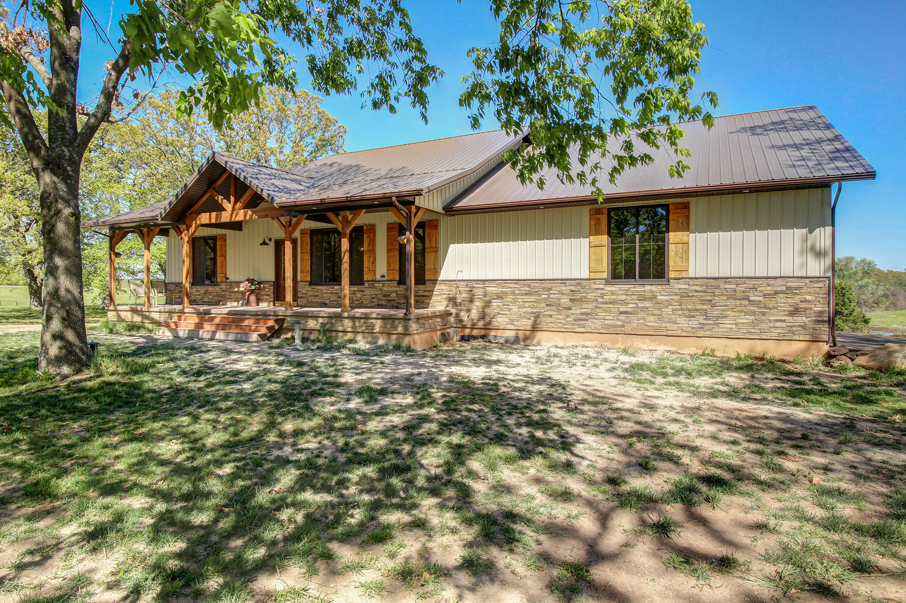 You absolutely must check out this 2022 new build. Paved drive with a park like setting. As soon as you walk in, you see craftsmanship and love that went into the home. There are custom rustic knotty hickory cabinets throughout the home. The floors are luxury vinyl plank. The ceilings are knotty pine. And the trim in the home is solid pine. There's a central vac system . Everything is upscale. There are five bedrooms three bathrooms. A spectacular movie room that is insulated all the way around to make it soundproof. A natural stone fireplace in the basement and upstairs is fantastic. Custom Anderson windows lets in lots of natural light and makes for awesome views. There's also granite countertops in the kitchen and cultured marble in the bathrooms. The home also has 6 inch walls and has spray foam and cell insulation for very efficient utilities. They run around $300 a month.You will love the LARGE pantry with a pass through door from the garage !!!! So easy to unload groceries. Master is large and has doors that lead to the 30 X 10 deck. LARGE  bathroom with a heated tub Large walk in shower with a seat and a FANTASTIC LARGE Walk in closet.  there is a wonderful garden area that is 200 x 40 with a hydrant for water. There is a fantastic 40 x 60 shop/barn with a bathroom in it water, electric and 220 hook up as well. There's also a barn that is 30 x 40 with electric to it. A nice pond and correl system for your livestock There's also an extra septic tank on the other side of the shop and water line that goes underneath the road to the other part of the property to a automatic water so you can run cattle horses. Whatever you choose. Amazing covered deck in the back with $1 million view. Great for entertaining. Location is fantastic. I could go on and on. But you need to see this fantastic new build. There's also a camel dairy farm across the road your visitors and kids would definitely love seeing that as well.