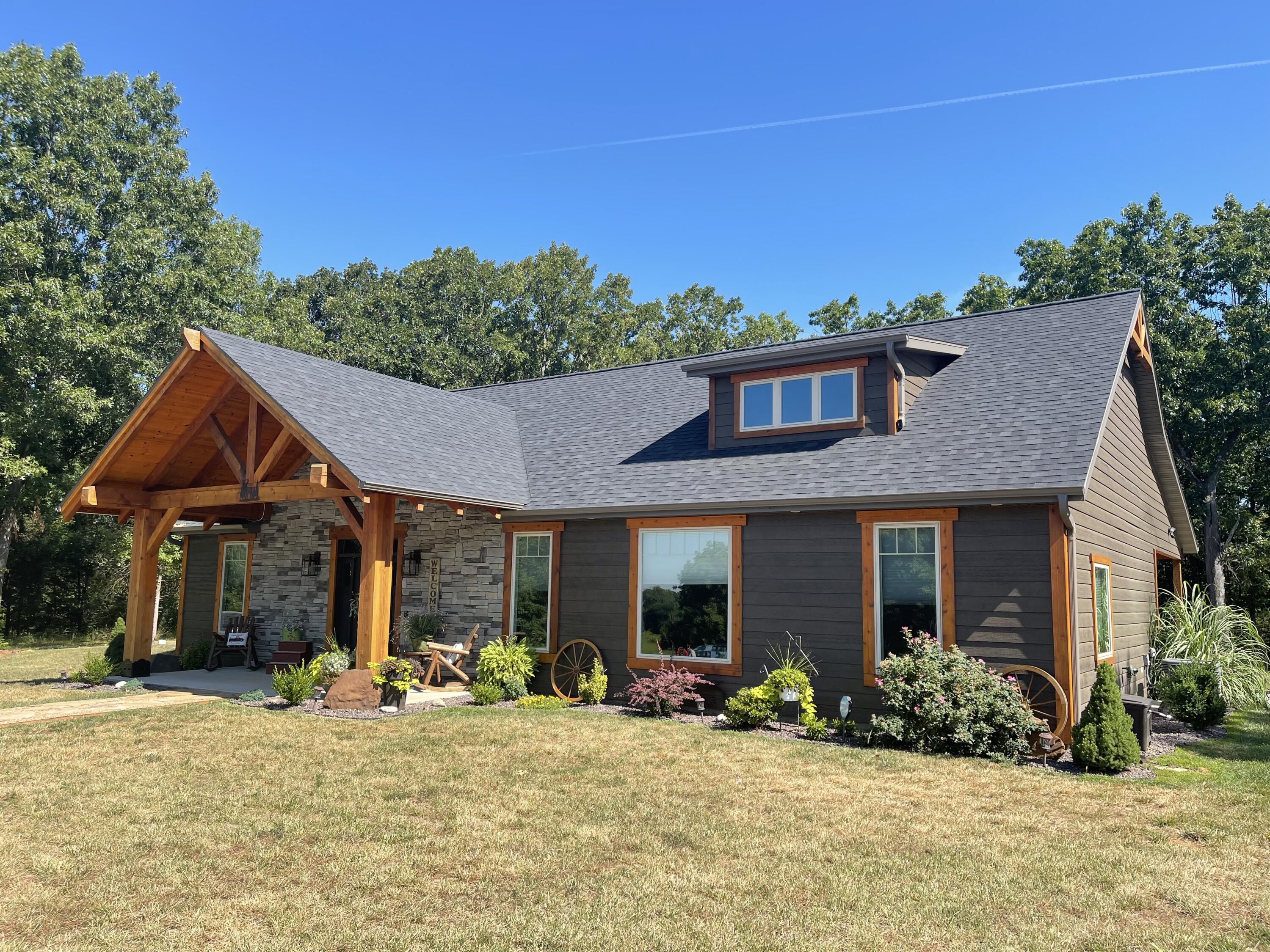 If quality in a home is important to you, then this 3 bed, 2 bath western-style ranch home should be on the top of your list.  The craftsmanship on this ~1,700 sq ft house is evident both outside and inside.  A gable-style porch introduces the property with Douglas Fir pillars, Cedar rafters, and Pine decking.  The inside boasts a vaulted ceiling that is complimented by a gas fireplace and an open kitchen-dining room-living room floor plan that buyers desire. A conversation pieces is the 10'x10' barn wood oak beams that transition the kitchen the living room. This is a unique feature almost exclusively to this home. Kitchen features include copper farmhouse sink, custom cabinets, island seating space, granite counter tops, stainless appliances, subway tile backsplash, and pot filler faucet. The home is a split-bedroom design with 2 guest bedrooms and 1 full bathroom on the west side of the home, and the master bedroom/bathroom suite on the east side.  The 2 guest bedrooms feature sliding barn doors, expensive fixtures, & rich paint colors. The master bedroom features access to a luxurious bathroom with a free-standing tub, 2 sink & mirror stations, impressive cabinetry, stand-up shower, large walk-in closet, and amber or LED lighting (your choice) depending on your ambience preference. The final 3 rooms of the home are the utility/pantry combo, mud room, and mechanical room.  The quality of the home is also less evident in the things that you don't see, for example: Ring doorbell system, Ecobee thermostat, high speed internet, whole home dehumidifier, fresh air HVAC intake, no-rust hot water heater, filtration/softener combo, motion lights, water hydrants, storm shelter, and Christmas light soffit outlets with inside switches. The exterior of the property boasts 2 outbuildings and 34 beautiful acres located about 7 miles east of El Dorado Springs. This property is located about 15 miles to Stockton Lake, 20 miles to Truman Lake, and 30 miles to Pomme de Terre Lake.