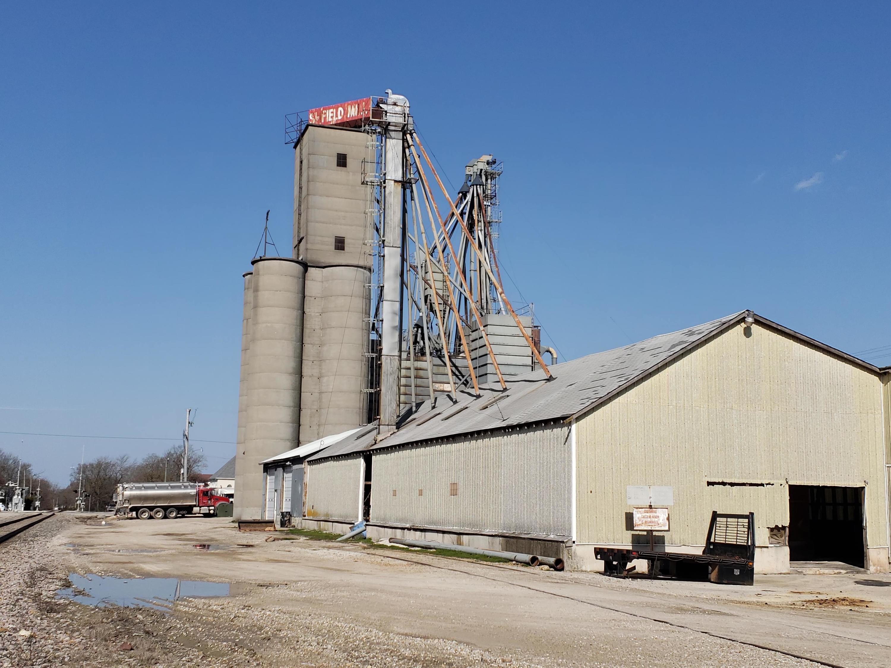 OPPORTUNITY OF A LIFETIME TO ACQUIRE ONE OF SW MO OLDEST AND MOST WELL RESPECTED AGRICULTURE BUSINESSES. OWNER IS RETIRING.  Marshfield Mills has been in the same family for over 40 years.  Business was first established in Marshfield over 70 years ago. Mill presently manufactures beef, dairy, hog, poultry sheep, goat, horse and other custom made animal feed products. Equipment includes: pellet mill, steam roller, crimper, grinder/hammer mill, 2 boilers, and much more for top quality feed production. Seller has all equipment and building in place to sell fertilizer but is not selling fertilizer at this time due to large growth of bulk feed business. Production average is approximately 90-100 tons per day. On site storage capability 40,000 to 50,000 bushel. 5 bulk delivery trucks plus 3 over the road semi tractor trailer trucks and one liquid tank trailer.  Skid steers and fork lifts sell with business along with office equipment and other small equipment needed for operation. Well established bag and smaller product business that is very competitive. Well known professional tire shop only 2 blocks from Mill does tire service for seller.  Well known diesel service shop located about one mile from the Mill.  Seller has had very prompt service from both companies when needed.  Down time is very minimal, since time is very important to business.