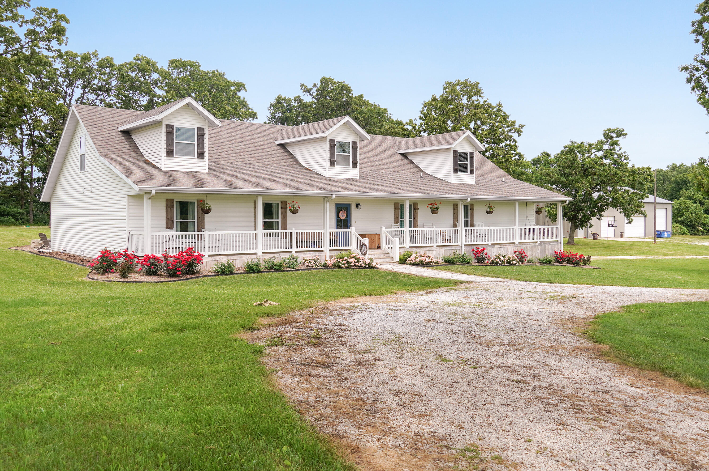 Incredible property right in the heart of Nixa! With six bedrooms and five bathrooms, this beautiful farmhouse is spacious enough for the whole family! Nearly all bedrooms are on the main level, one being an en-suite, in addition to the spacious master bed/bath. The kitchen is amazing and the pantry is absolutely perfect; it's a room of its own! You won't find this kind of space anywhere else! The upstairs is an excellent second living room/entertaining area, with a full bath and non-conforming sixth bedroom, there are so many options, along with multiple storage areas! The mudroom off of the kitchen connects to a large laundry area and built-in storm shelter. The main home includes three garage bays. An additional three plus garage bays can be found in the 50' x 63' shop; complete with concrete floor, electric service, and plenty of parking space, including a 13' RV door with 50amp RV electric service ready to go. You can't beat the newly installed back deck with professionally poured fire fit and custom pergola; absolutely a perfect spot to entertain!  Did you see that front porch?!... nothing like it on market and there won't be anytime soon, incredible spot to relax the day away! All of this sits on a stunning 5 acres in one of the very best spots in all of SW Missouri. The highly awarded Nixa school district and farm life awaits you at this very well-cared for home. You can walk to High Point Elementary across the field next to your home! The very popular Nixa Recreation Center is minutes away, as is the Jr. High and all of the dining and shopping Nixa has to offer. This is an opportunity that rarely comes about, make sure this is on your list to check out!