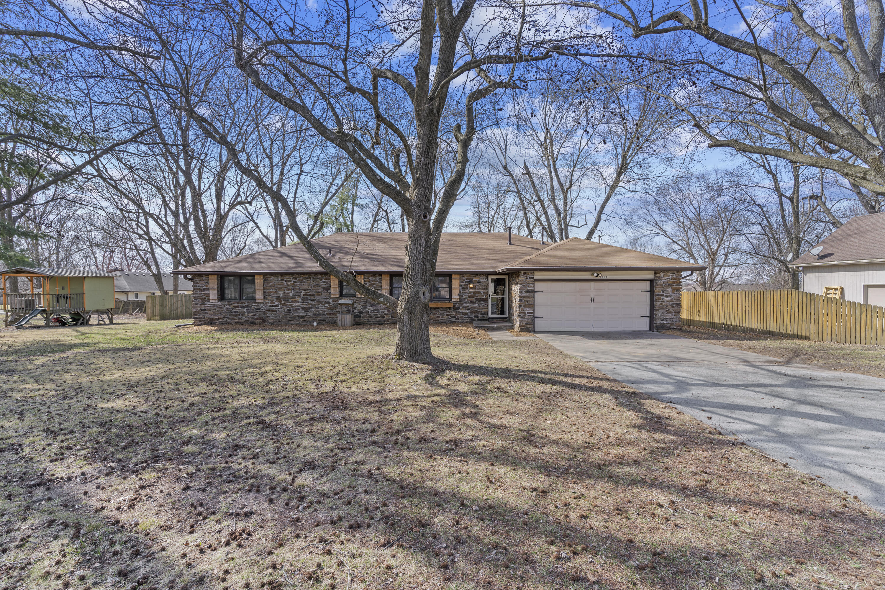 You'll instantly feel at home the moment you step inside this beautiful well-maintained home!  Sitting on a quiet, tree lined street, this single-story home boasts over 2,400 sf and is full of modern updates. The home features 4 spacious bedrooms and 2.5 baths.  The large, well-appointed kitchen features new cabinetry, a new dishwasher, new lighting, a pantry with pull-out shelves and an added island for plenty of storage.  The dining room has a gorgeous rock fireplace that has been recently converted to gas.  Most of the home has engineered hardwood floors except for the tile bathrooms.  Step outside into your backyard oasis.  The expansive deck has been covered by the new roof and overlooks the amazing fully fenced yard!  The new pool was added in the spring of 2022.  The 30 x 40 shop has electricity, concrete floors, and an additional covered bay for boat or trailer storage.  Call today for your private showing.  This home certainly won't last long!