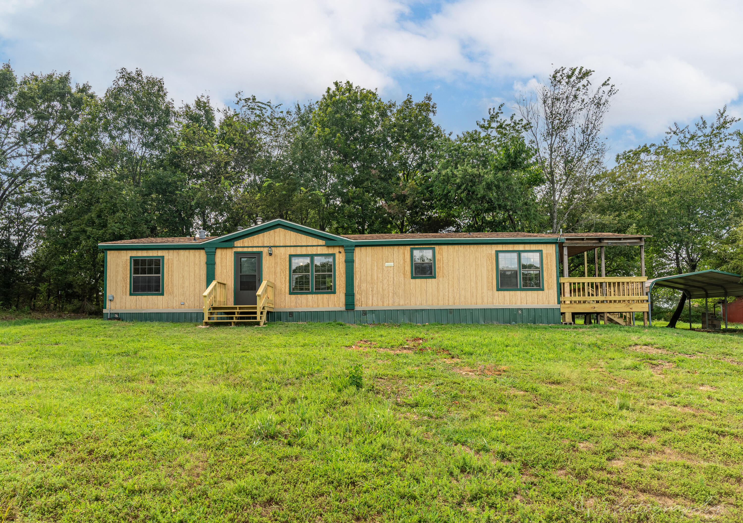 :Almost 32 fantastic Acres less than a 25 minute drive to Northwest Arkansas. Two ponds, cattle tight fencing, 42 x 42 Shop with electric, 21.5 x 42 Lean to, and a chicken coop! The doublewide features a 11 x 27.5 new deck, new heat and air, new storm door and McDonald County water. Propane tank is leased from MFA. The 3 bedroom 2 bath home has a large kitchen and living area. Several building spots for your perfect home. Bring your animals and enjoy living in the country!