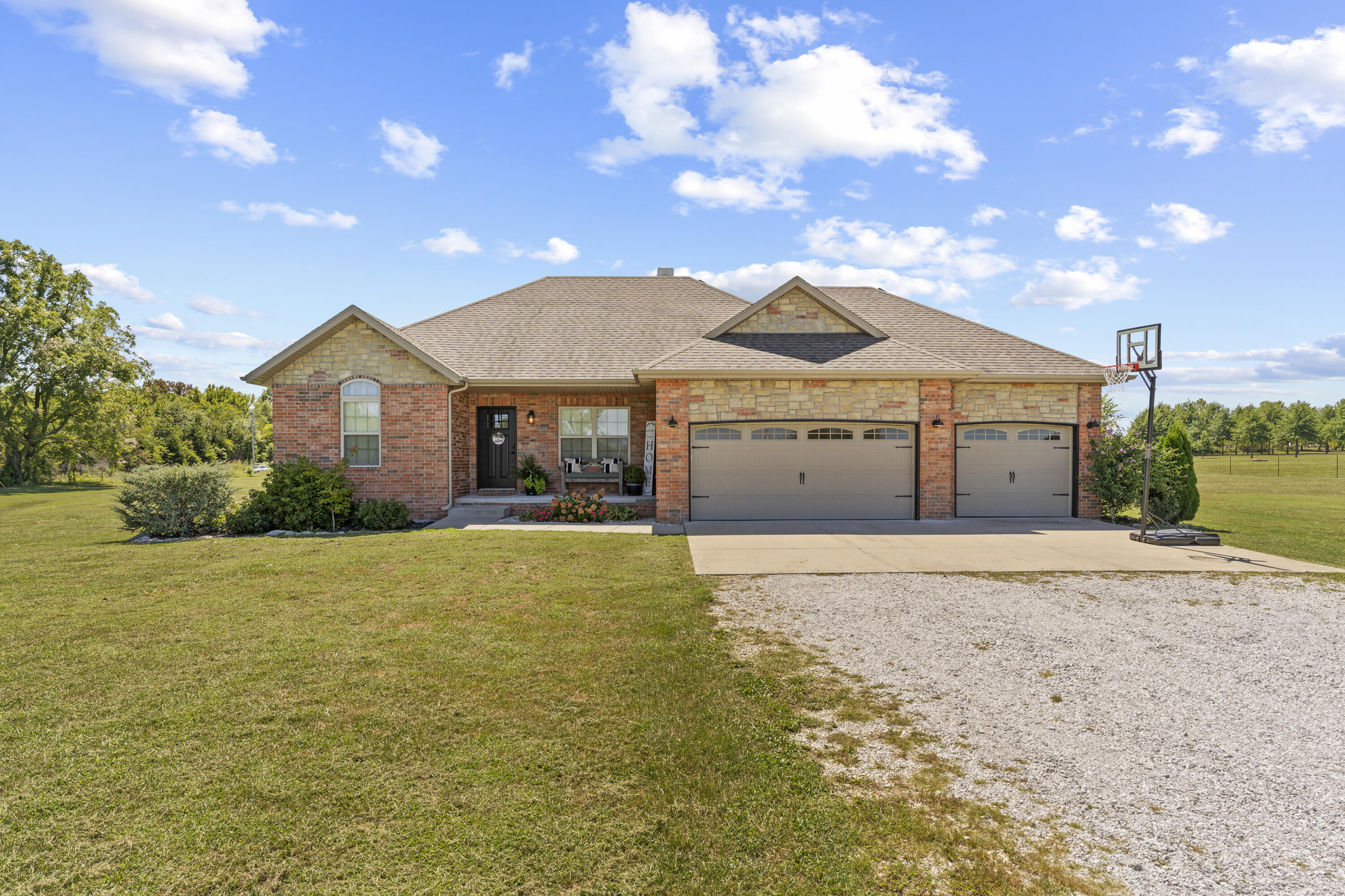 NO RESTRICTIONS!!Welcome to your dream home in the highly sought after Gold Ridge Subdivision. This stunning property, built in 2016, sits on 3 flat acres. This home also features a spacious 3-car garage and beautifully maintained landscaping. As you approach the home, you'll be greeted by a welcoming front porch and gorgeous brick front.Step into the open-concept living area where vaulted ceilings and engineered hardwood floors create an airy, elegant atmosphere. The updated kitchen is a chef's delight, boasting sleek quartz countertops, ample cabinetry, and modern appliances. The adjoining dining and living spaces are perfect for both everyday living and entertaining. The home includes three generously sized bedrooms and two bathrooms. The master suite is a true sanctuary, featuring a large walk-in closet and a relaxing layout. The two additional bedrooms offer versatility for family, guests, or a home office. Enjoy outdoor living at its finest with a covered back patio that overlooks a well-designed backyard entertainment area. Whether you're hosting summer barbecues or simply unwinding after a long day, this space is perfect for making lasting memories.Don't miss out on this exceptional opportunity to own this well maintained, beautiful home. This property is located in the Clever School District! Positioned between Republic and Clever, you are short drive to all the convinces both towns have to offer. Schedule your visit today and envision yourself in this beautiful home!