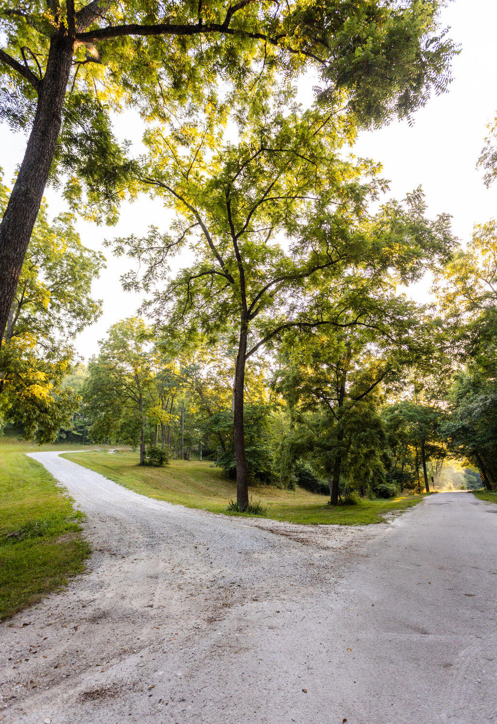 This stunning property encompasses 32 +/- acres of unrestricted land and includes a very well-maintained brick home, newly built shop house, large equipment barn, and much more. As you pull into the property you will appreciate the mature walnut trees scattered along the entrance. At the end of the driveway, you will be greeted by a charming home perched at the top of the ridge. This all-brick home features all the essentials for comfortable living. Spanning about 3,205 +/- square feet, the home offers an attached three-car garage, spacious living areas, a walkout basement, and a beautiful kitchen. Inside, you'll find 4 bedrooms and 3 full bathrooms. The master suite, one spare bedroom, and one guest bathroom are located on the main level, while the two remaining bedrooms and one bathroom are located in the basement. The newly built shop house is both practical and delightful! It was built in 2021, measures 2,800 +/- square feet, and includes a full kitchen, full bathroom, laundry room, and even temporary living partitions which could be removed or left in place to accommodate your needs. If you still need extra space to store your equipment or a place to work on projects, an additional 40'x20' equipment barn is located just across the yard. As an added bonus, the property features a custom-built solar energy system, providing 10 KW of sustainable and eco-friendly power to the house and both shops. The property also features an outdoor wood-burning furnace. When in use it provides hot water for the entire house, as well as heats the entire home through a heat exchange on the indoor furnace. If you choose not to utilize these off-grid functions, the propane and on-grid electric can take over. These unique features offer an off-grid experience that seamlessly blends with modern convenience, all while providing major cost savings. Outside, approximately 12 acres of pasture await and about 20 acres of hardwoods allow you to enjoy some quality time in the outdoors.