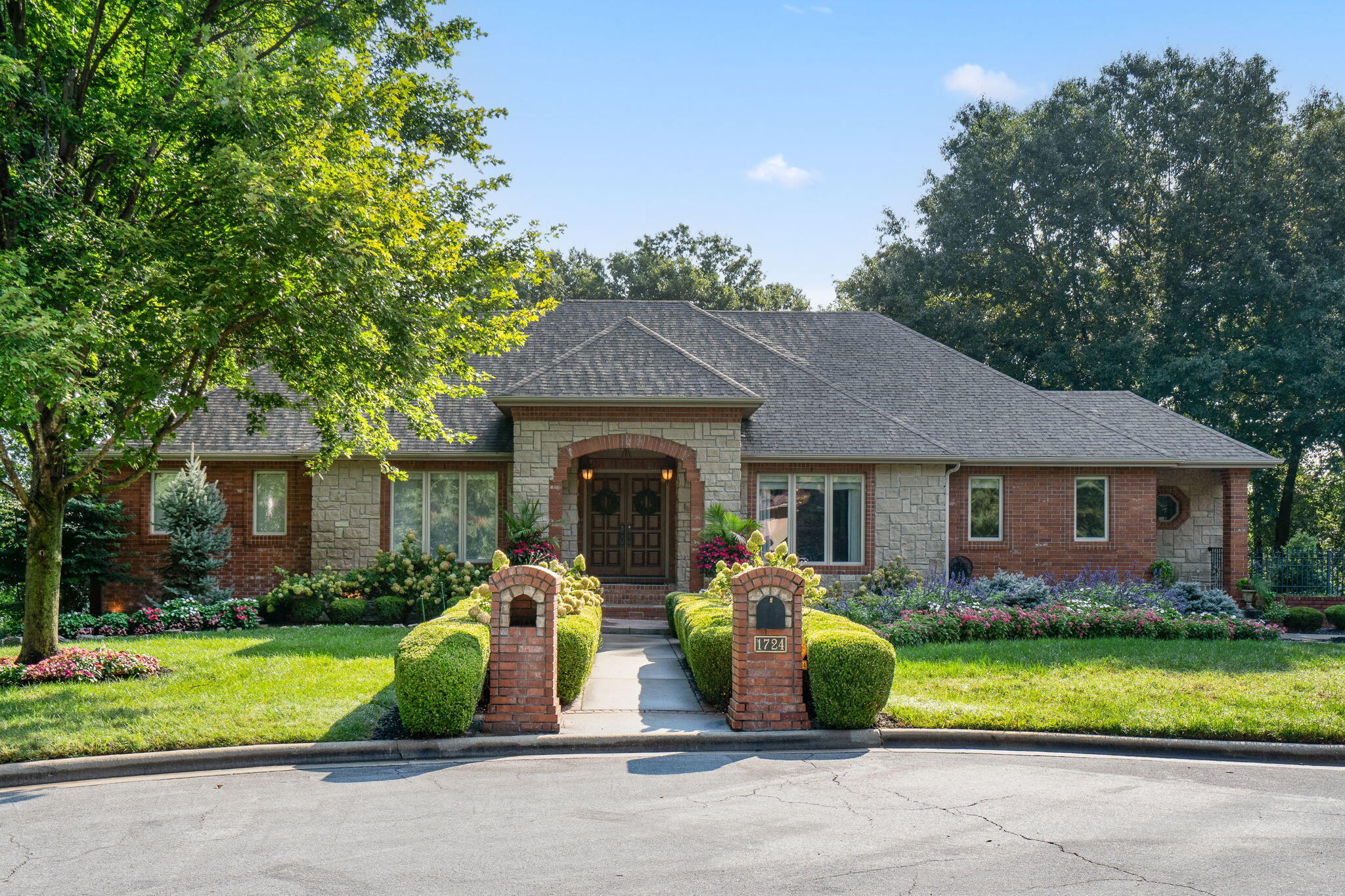 Stunning home designed by Dale Peer on 1.5 acres in Chapel Hill Subdivision! This East Springfield home is all brick with a walk-out basement and features 4 bedrooms, each with an en-suite, an office, and a powder room. Inside the Mahogany front doors, enjoy a stunning formal living room with crown molding, a gas fireplace with marble surround, and tall ceilings. The formal dining room offers a Venetian plaster ceiling, and Cherry hardwood floors that extend into the kitchen. The kitchen features Cherry cabinets, granite counters, a large center island with Dacor gas cooktop, a Dacor warming drawer, walk-in pantry, and attached hearth/dining room. Adjacent to the hearth room is a sunny den with exterior access to the back deck. The luxurious primary suite provides a see-through gas fireplace, private balcony, dual vanities, a jetted tub, walk-in tiled shower, all new plumbing fixtures, a walk-in closet with built-in wardrobes, and a private laundry room. A prime feature of this house is the unique doorway off the closet into an upstairs office. The professionally designed 2nd floor office (Obelisk Home) includes cabinets from Concepts By Design, a built-in screen that lowers into the desk, recessed cove lighting that highlights a gold leaf ceiling, and so much more! The main floor is completed by one more bedroom w/private bathroom, and a central powder room. Down in the basement, you will love the spacious family room with a dining area and full bar. There are 2 bedrooms, one that makes a perfect in-law suite, a storage room, and safe room. Another jewel of this home is the theater room with coffered ceiling and tiered seating. Off the basement is a screened in patio and 3-car garage. Property is situated in Glendale School district over three lots on a private cul-de-sac. This is a must-see home to truly appreciate all of the amenities and attention to detail!