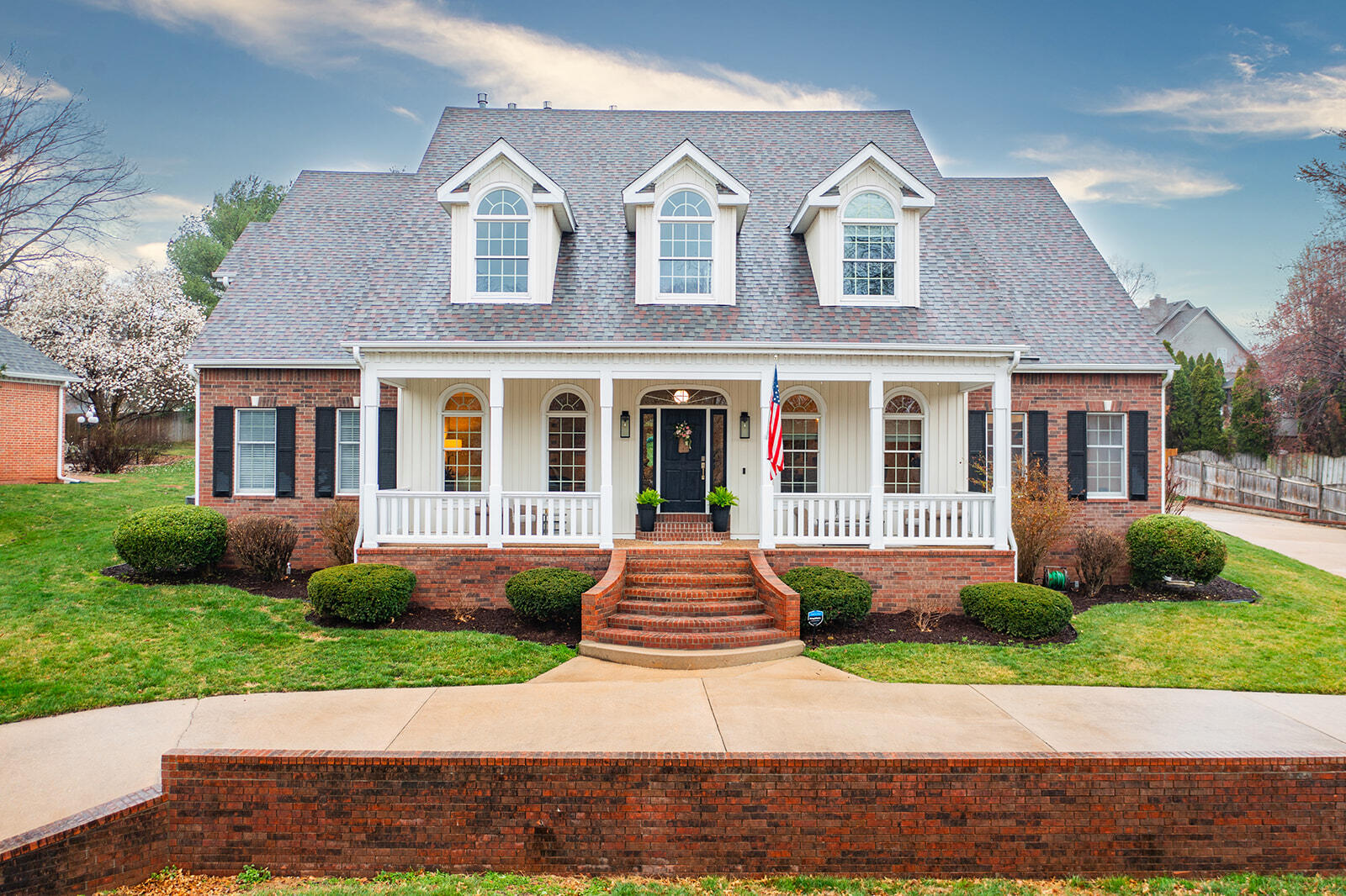 Absolutely stunning remodeled Ravenwood South beauty awaits you in this Southern Living magazine-worthy home! Step inside to soaring ceilings that create an airy and inviting atmosphere. Gorgeous hardwood flooring spans both levels, complemented by plush new carpeting in the bedrooms.Prepare to be wowed by the expansive kitchen, a chef's delight featuring a substantial island perfect for gathering around. New Alder kitchen cabinets offer ample storage, while the dazzling Quartz and granite counters provide both style and functionality. The kitchen is further enhanced with gas cooktop, new farmhouse style sink, convenient pull-outs, and a walk-in pantry providing plenty of space for necessities and storage.The primary bedroom suite is a true retreat, boasting new rectangle tile floors, his and her vanities, a private soaking tub for unwinding after long days, and a closet that you have to see to believe!Every bedroom in this home is generously sized, with closets to match, ensuring comfort and convenience for everyone. Don't forget to discover the 'secret' playroom, a delightful surprise for the young and young-at-heart alike!Outside, the large manicured yard beckons, complete with a sprinkler system to keep it lush and green. Enjoy the Ozarks weather on the covered patio or relax on the fantastic covered front and rear porches, perfect for morning coffee or evening gatherings.This home also features a side entry 3-car spacious garage, providing plenty of room for vehicles and storage. Designer details are found throughout, adding an extra layer of elegance to this already impeccable home.Not only is this home stunning, but it's also incredibly efficient thanks to its custom SIP (Structural Insulated Panels) construction. Say goodbye to sky-high utility bills, as this home keeps them amazingly affordable without sacrificing comfort or style.