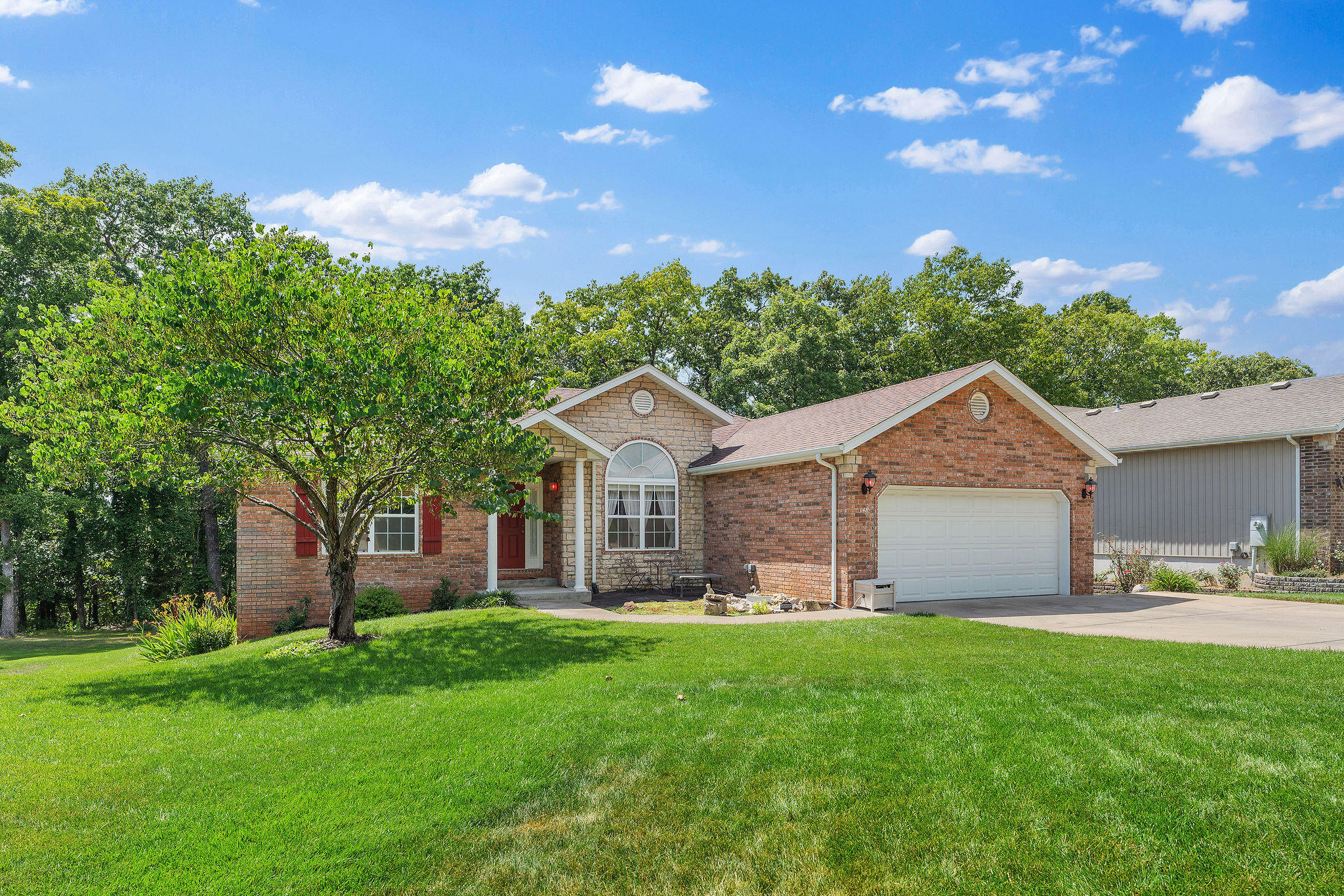 Best value on the market!! Exceptionally spacious and well-maintained home on the quietest street in the neighborhood. Backing up to the woods of Mills Hollow, this setting is peaceful and serene, and with 5 bedrooms, 3 bathrooms, and 2 living areas, there is room for everyone! This one-owner home has excellent curb appeal; the lovely brick and stone front is offset by charming white pillars, and there is a delightful fountain nestled in the landscaping. The extra wide (and FLAT!) driveway makes parking a breeze! The main level features a foyer, a big living room with bamboo flooring and a see-through fireplace that leads to the hearth room. There is also a dining nook, a nice kitchen with peninsula, formal dining room with 12 foot ceilings, master bedroom with en-suite bathroom, walk-in closet, walk-in shower and bathtub, 2 generously-sized guest rooms, additional bathroom, and laundry room. Downstairs there is a massive family room, big enough for both game tables and living space, 2 more bedrooms, a full bathroom, and a large storage area. There is also a built in Bose Acoustimass speaker system. Located on the backside of the Horizon Hills neighborhood on a quiet, culdesac street, there is minimal traffic. Perfect north side location that is super close to Branson Buchanan Schools, the Highroad, Hwy 65, Branson Hills shopping, golf, dining, and more. Just 5 minutes to Roark Creek, The Ruth and Paul Henning hiking trails, and the new Ozark Mountain State Park. In 15 minutes you can be at both Table Rock Lake and Lake Taneycomo, the Branson Landing, Silver Dollar City, and to all the attractions and activities of Branson. Low HOA dues include sewer and water. New roof with upgraded hail-resistant shingles 10-31-17, new water heater March 2020, new fridge 2020, new garbage disposal 2020. Upgraded insulation in attic. Super low electric bills! White River is currently installing fiber optic in the neighborhood. Some furniture negotiable.
