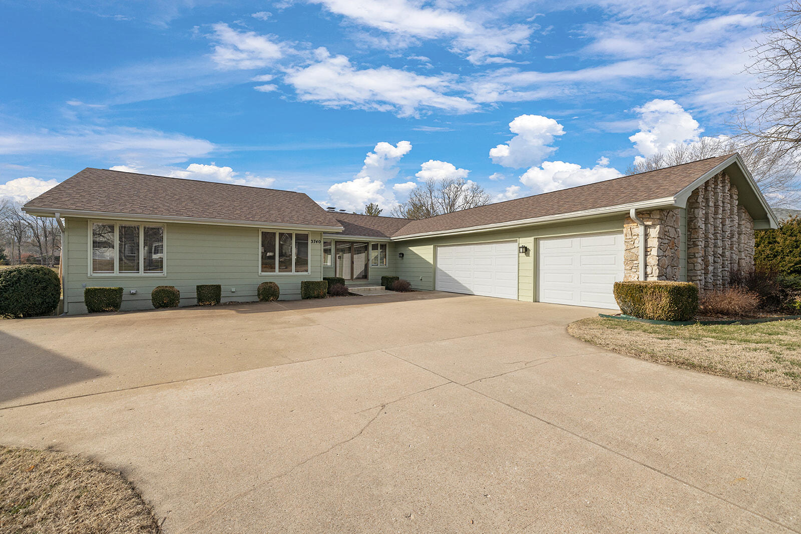 Welcome to this beautiful, mid-century modern, custom home in the quaint Cinnamon Square neighborhood. Located on a quiet cul de sac on almost  1/2 an acre, this home is a 4 bedroom, 3.5 bath with a 3-car garage.Walk through the unique double wooden doors into the inviting, large living room with vaulted ceilings and rock fireplace. The kitchen is complete with  all new stainless-steel appliances and new solid surface countertops.  Enjoy a glass of wine from the wine refrigerator or a coffee from the coffee bar to savor on the attached walk out deck. Love to entertain?  This is the house.  The living area opens to a large formal dining room flanked with amazing windows to enjoy your view. Want a large area to gather for the big game?  The walk out basement has a large second living area complete with a wet bar, full refrigerator, and cooktop. This amazing home is updated from the top to bottom with a newer roof, gutters, garage doors, appliances, carpet, paint and more. This is it!  This home is move in ready!