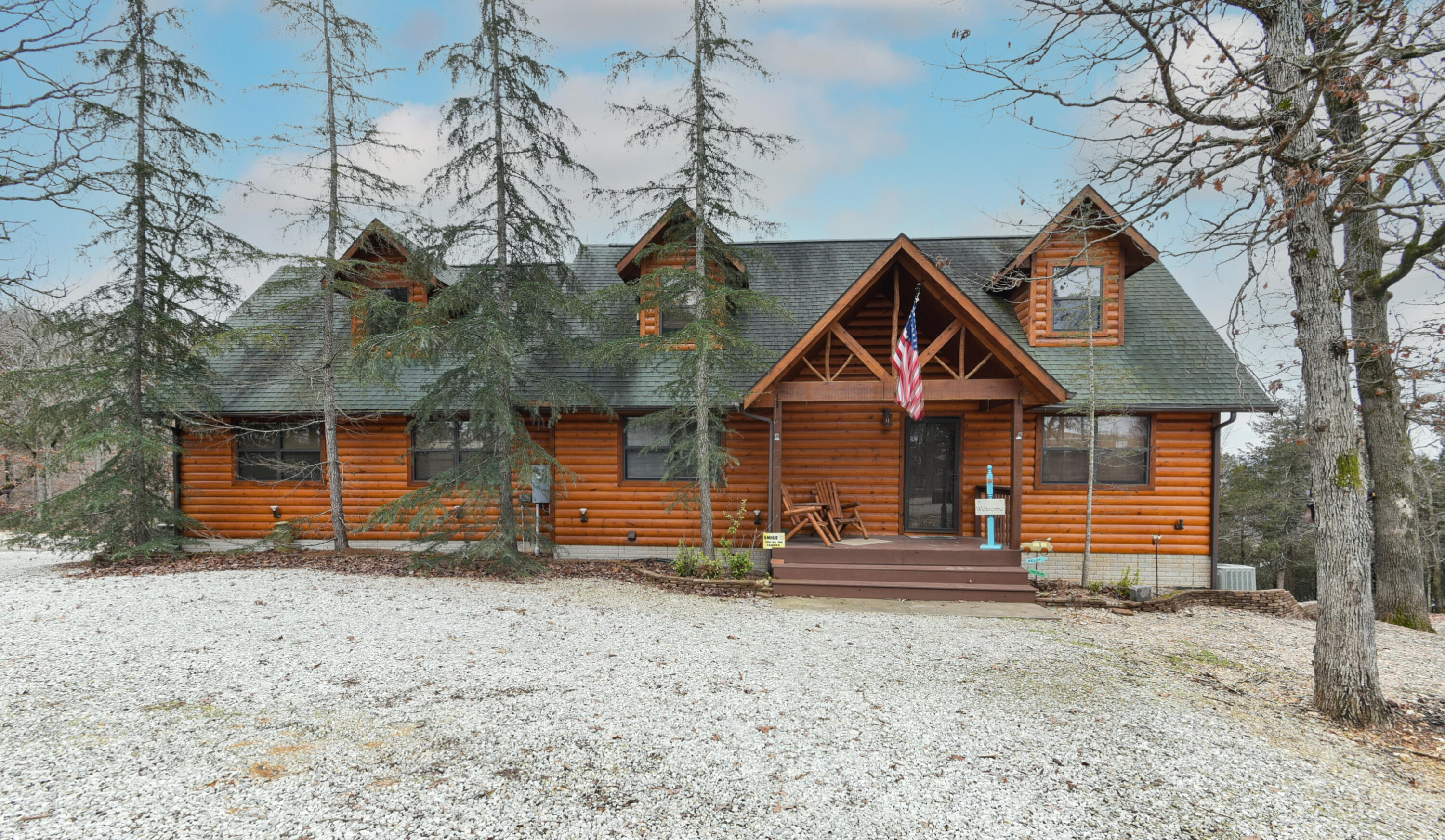 Hard to find lake front property large enough for you and your friends with over 3200 sq ft!  This 3 bedroom 3 bathroom log sided chalet sits on 1.5 acres with a bluff scene of Table Rock Lake.  As you enter the main door, you will be in awe of the vaulted ceilings and exquisite windows that boast a view of the lake.  The large 2 car garage could possibly serve for boat storage or keep the current setup as a game room.  If you like to entertain, the basement wet bar, family room and bathroom provides an area for lots of memories. Imagine sitting on one of the 3 covered decks and spotting our famous Bald Eagles or other fantastic wildlife.  No restrictions - seller is conveying completely furnished so Vacation rentals are a possibility.  Currently set up to sleep 18 people!   Eagle Rock marina is just down the highway for a boat launch or possible slip rentals. An RV hookup is also on the property for extra guests.  Roaring River trout fishing is only 10 miles away.  Close to Eureka Springs and only a day trip for Dogwood Canyon or Branson.