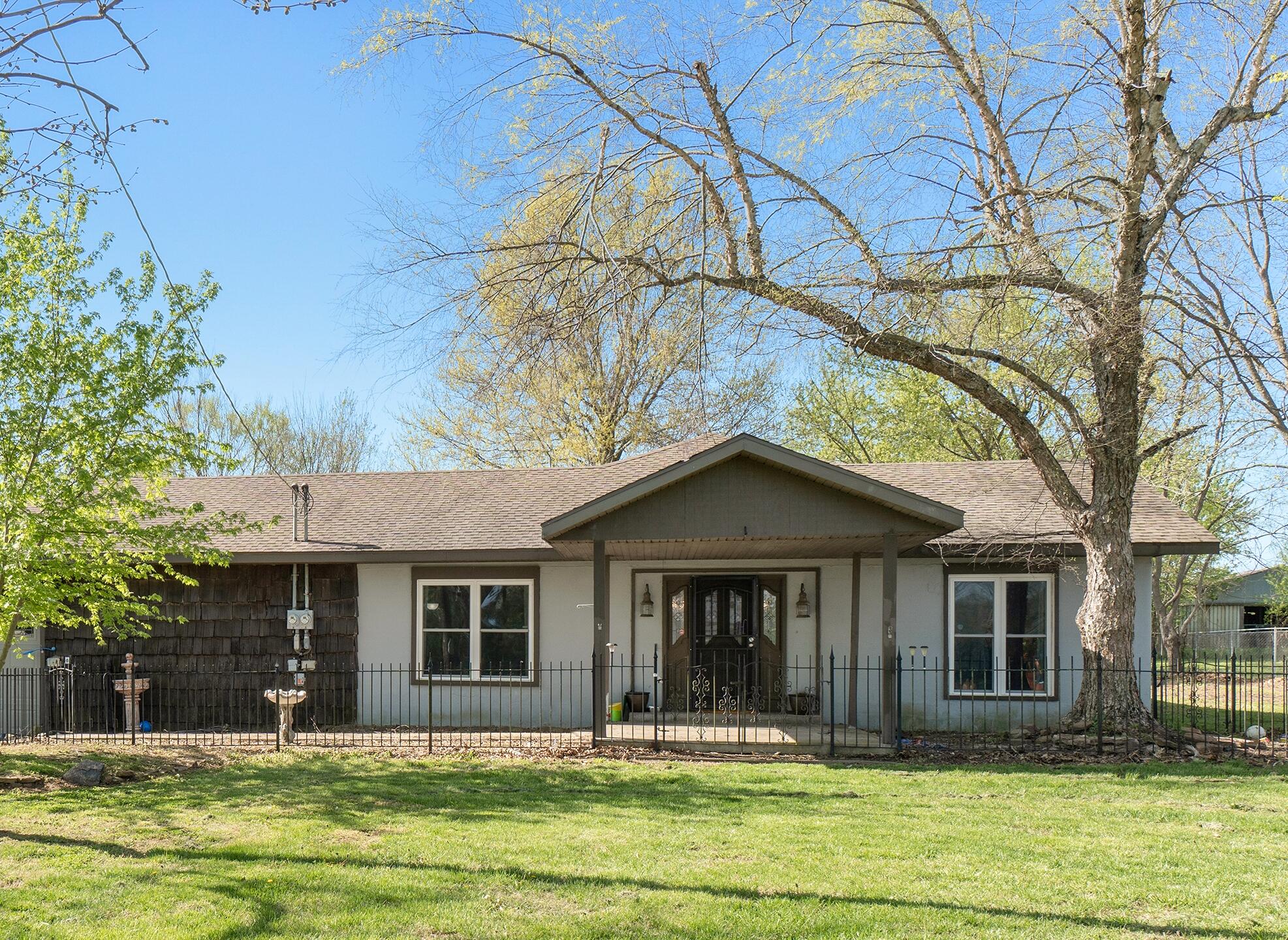 Wow! Talk about potential. This home boasts 2.5 acres, a mother in law quarters complete with W/D hookups, living area, full bath, kitchen and separate entry. In the main part of the home you'll find 2 large living rooms, dedicated dining space, and a multipurpose room off the garage with separate entry. 2 bedrooms in main house are nonconforming,  but each have 2 exits and have been licensed and approved for fire safety from DMH for fostering for the last 3 years. Three car oversized garage and separate outbuilding for shop or dog kennel are added bonuses! Potential horse property, minimal fencing to get it ready!