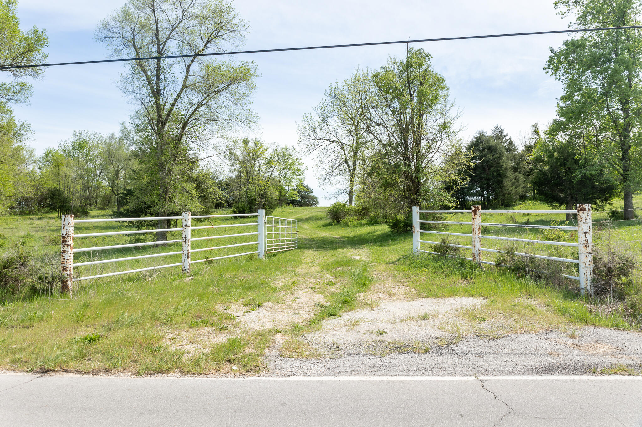 This 16.25 +/- acre property in Willard, Mo, is the perfect location to build your dream home. With a pond and fully fenced perimeter, you'll have privacy and tranquility on this picturesque hillside setting. The pipe fencing is a nice added touch to the entrance. Enjoy the seclusion of country living while still being just minutes away from all the conveniences and amenities that Willard has to offer. Whether you're looking to raise horses, cattle or simply enjoy the peacefulness of rural living, this property has endless possibilities.Don't miss out on this opportunity to create your own oasis in Willard. Contact us today to learn more and schedule a viewing of this stunning property.
