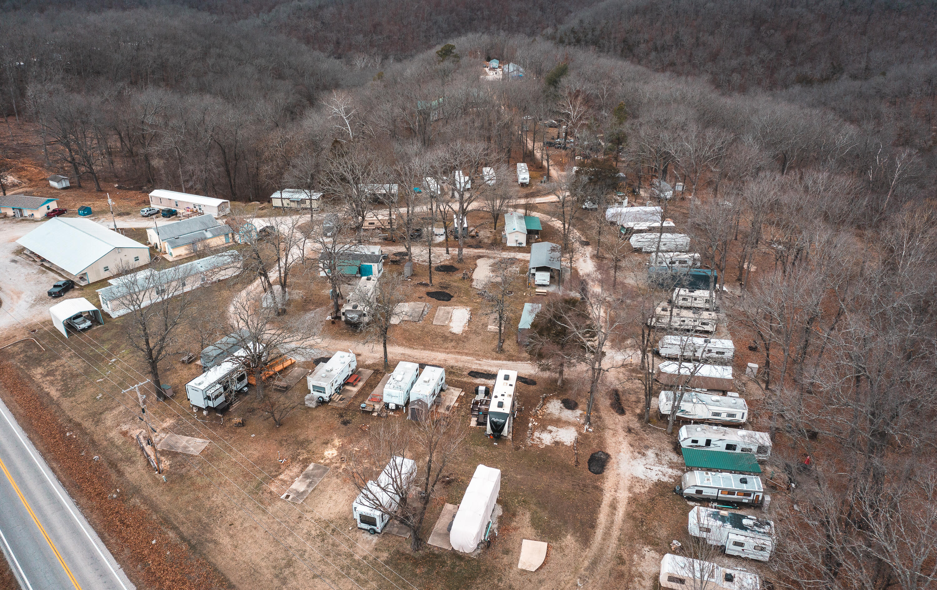 Located steps away from one of the most visited state parts in Missouri and less than 15 minutes from Table Rock Lake is Fisherman's Inn RV Resort.   Fisherman's Inn RV Resort has been a staple in the Roaring River State Park and Cassville, MO area for over 35 years.   Dotted under the many shade trees located on the approximately 17-acre resort you will find 50 full hook up sites complete with water, septic and individual electric meters, a large shower house with two separate shower rooms, a maintenance building and storage.  In addition to the RV sites, this property has multiple individual rentals that can be used monthly or nightly.  Rental 1 & 2 is a 40x80 building with a duplex set up, each duplex having 2 bedrooms and 2 bathrooms. Rental 3 is a 14x70 2 bed, 1 bath mobile home. Rental 4 is a 16x80 2 bed, 2 bath mobile home. Rental 5 is 18x65 wood framed 2 bed, 1 bath rental.   Rounding out this amazing property is the main home.  The 2560 sq foot 4 bed, 2 bath main home sits on a private drive a short distance to the north of the resort.  The main residence is on a permanent foundation and has a large 30x30 attached two car garage with ramp access to the home.   Don't miss your chance to own one of the few RV Resorts this close to Roaring River and Table Rock Lake.  Turn Key Opportunity Awaits!
