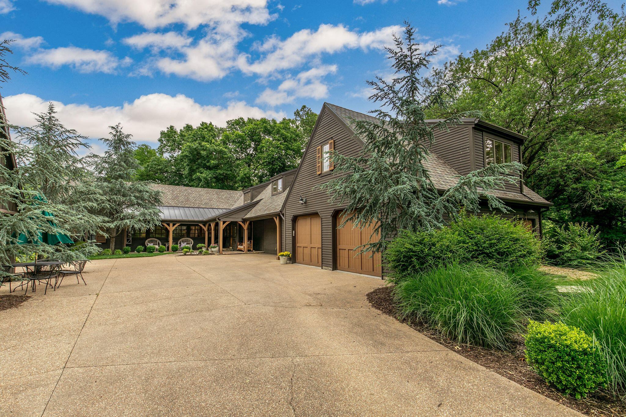 Exquisite custom-built New England style home sitting on 11.74 acres with Pearson Creek running through the back of the property, Located on East Catalpa, you will love the beautiful drive that leads to this home with a circle drive. This amazing home offers 6 bedrooms and 5 1/2 baths. A recent remodel includes top of the line features. Many upgrades include, hardwood floors, craftsman style posts and beams in the ceiling.  The phenomenal Chefs kitchen is equipped with commercial Viking appliances, a large island, and walk-in pantry. The kitchen is open to a dining room and a cozy hearth room with a stone, wood burning fireplace. The all weather, screened in porch is the perfect spot to build a fire in the second stone, wood burning fireplace and enjoy the view of the creek and wildlife. The beautiful primary suite is complete with two walk-in closets a gas stone fireplace, and a beautifully remodeled bathroom.Additional features include a home gym, and a temperature controlled garage with electric car charging station. The Party Barn is the perfect location to entertain guests and features a kitchen. Enjoy the views of Pearson Creek and the sights and sounds of nature at this stunning, one of a kind home.