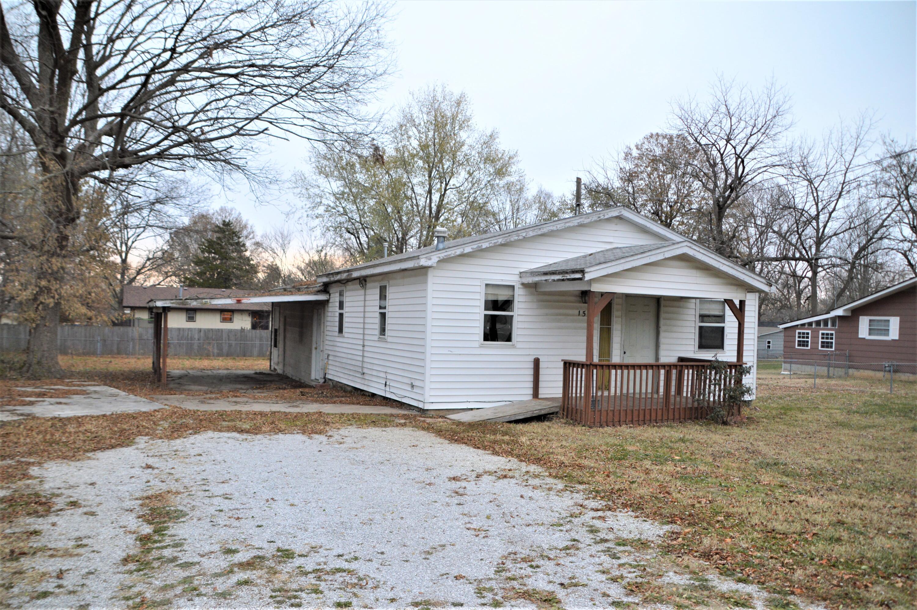 Great investment for this 3 bedroom 1.5 bath home with large open living room with cathedral ceiling and fireplace, attached carport and nice lot.  This home has some newer carpet, but will need work.  Will make great investment in quiet location close to schools.  Home was original a mobile and has been converted to permanent structure with a large addition.