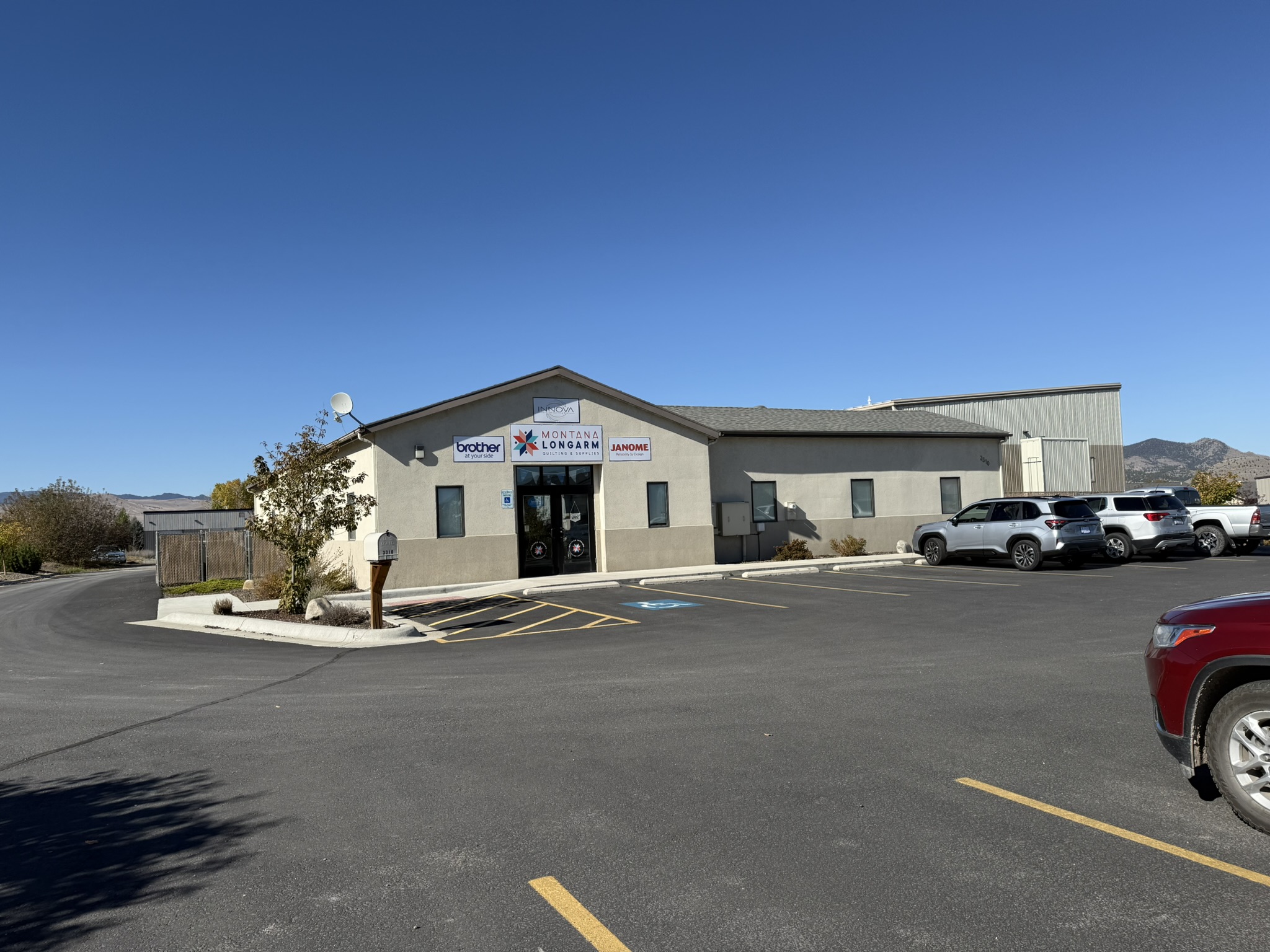 View of commercial property with uncovered parking and a mountain view