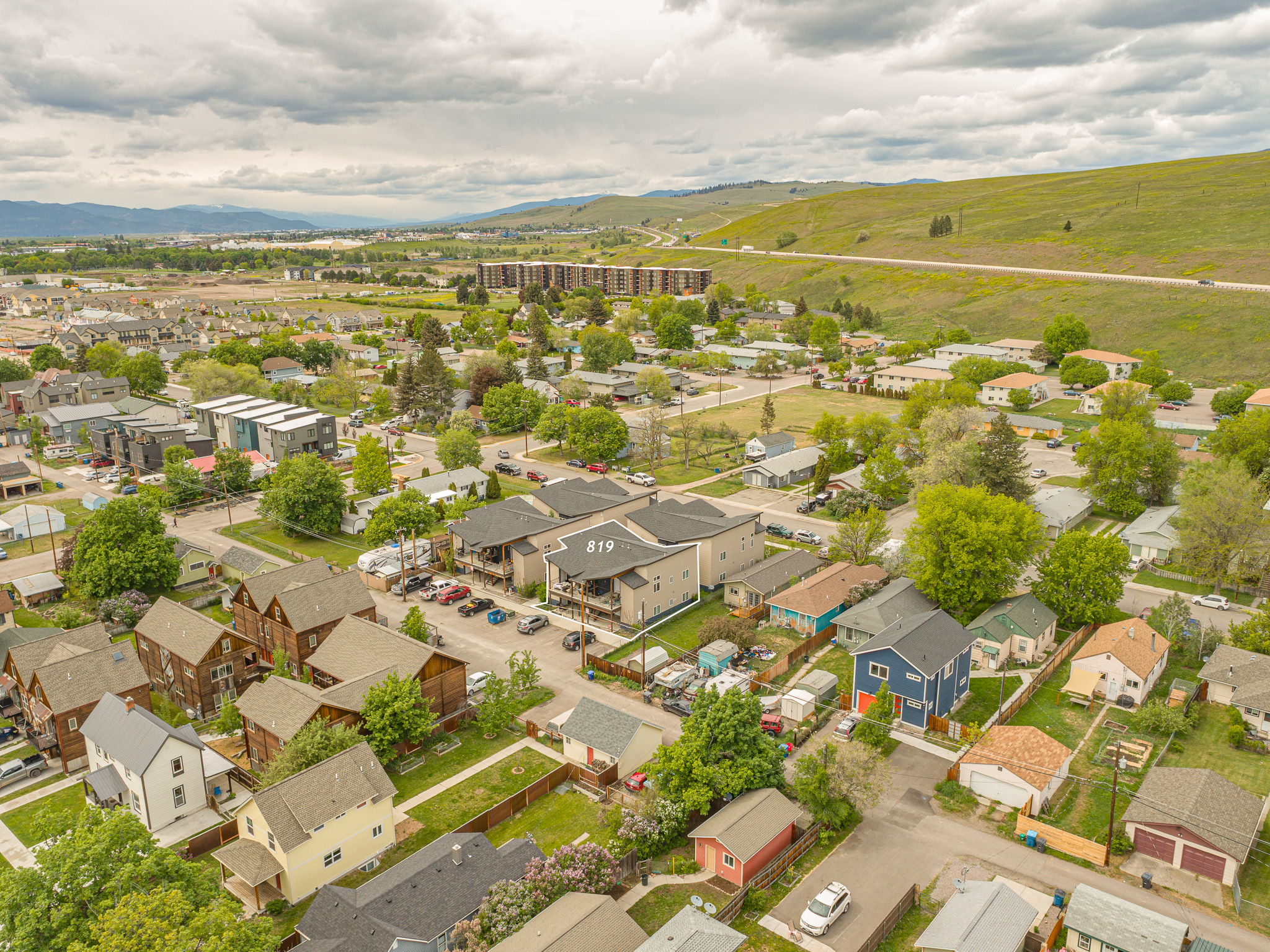 Aerial perspective of suburban area with a mountainous background