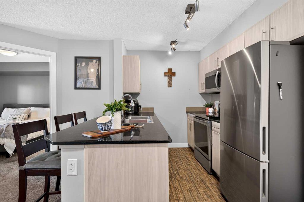 Photo of 403 Mackenzie Way SW #2403, Airdrie, AB T4B 3V7 (MLS # A2331163)