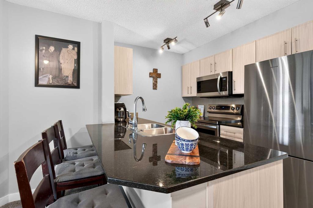 Photo of 403 Mackenzie Way SW #2403, Airdrie, AB T4B 3V7 (MLS # A2331163)