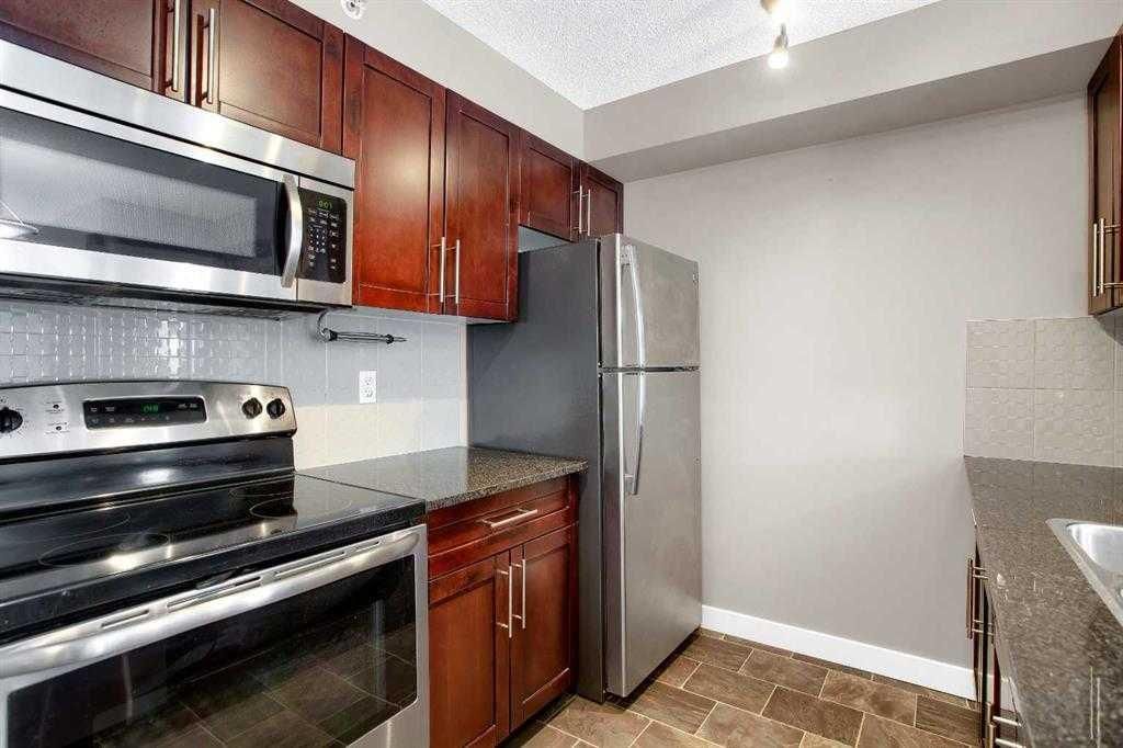 Photo of 403 Mackenzie Way SW #9407, Airdrie, AB T4B 3V7 (MLS # A2293383)