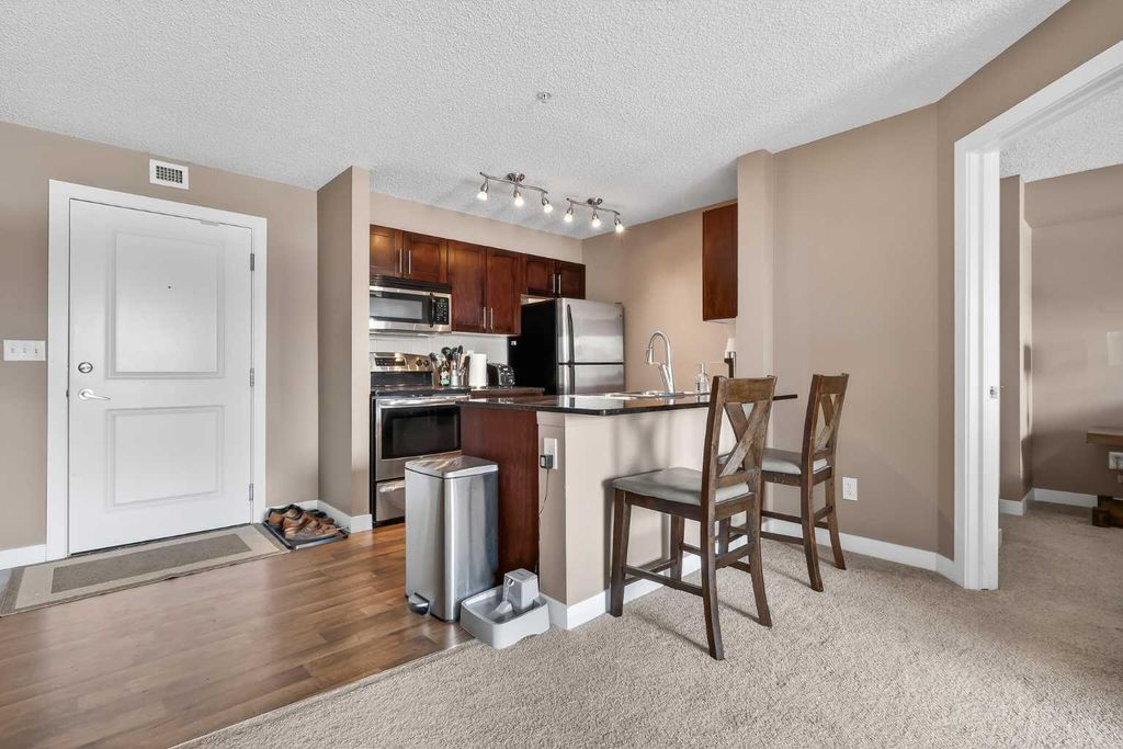 Photo of 403 Mackenzie Way SW #4317, Airdrie, AB T4B 3V7 (MLS # A2298434)