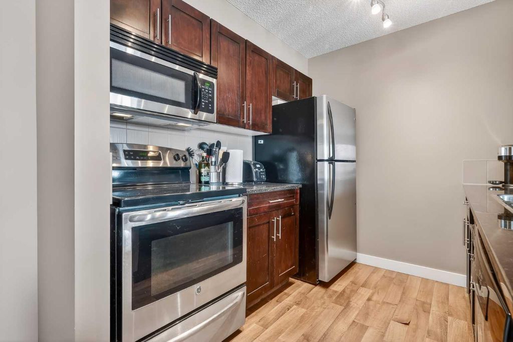 Photo of 403 Mackenzie Way SW #4317, Airdrie, AB T4B 3V7 (MLS # A2298434)