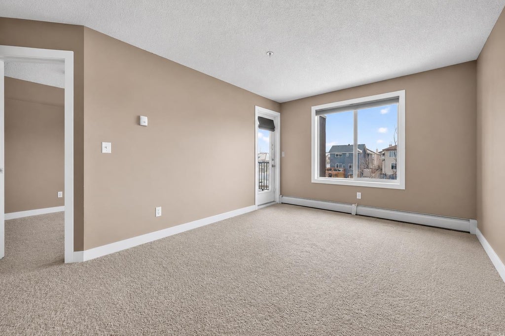 Photo of 403 Mackenzie Way SW #4317, Airdrie, AB T4B 3V7 (MLS # A2324086)