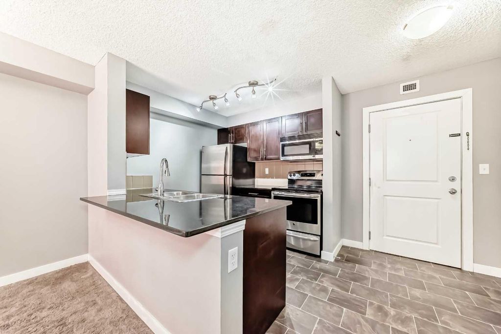 Photo of 403 Mackenzie Way SW #4304, Airdrie, AB T4B 3V7 (MLS # A2306542)