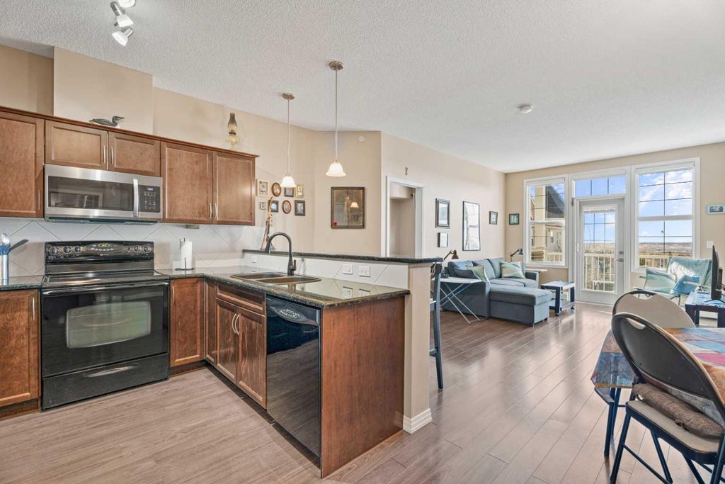 Photo of 1 Crystal Green Lane #410, Okotoks, AB T1S 0C5 (MLS # A2300391)