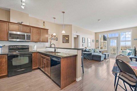 Photo of 1 Crystal Green Lane #410, Okotoks, AB T1S 0C5 (MLS # A2300391)