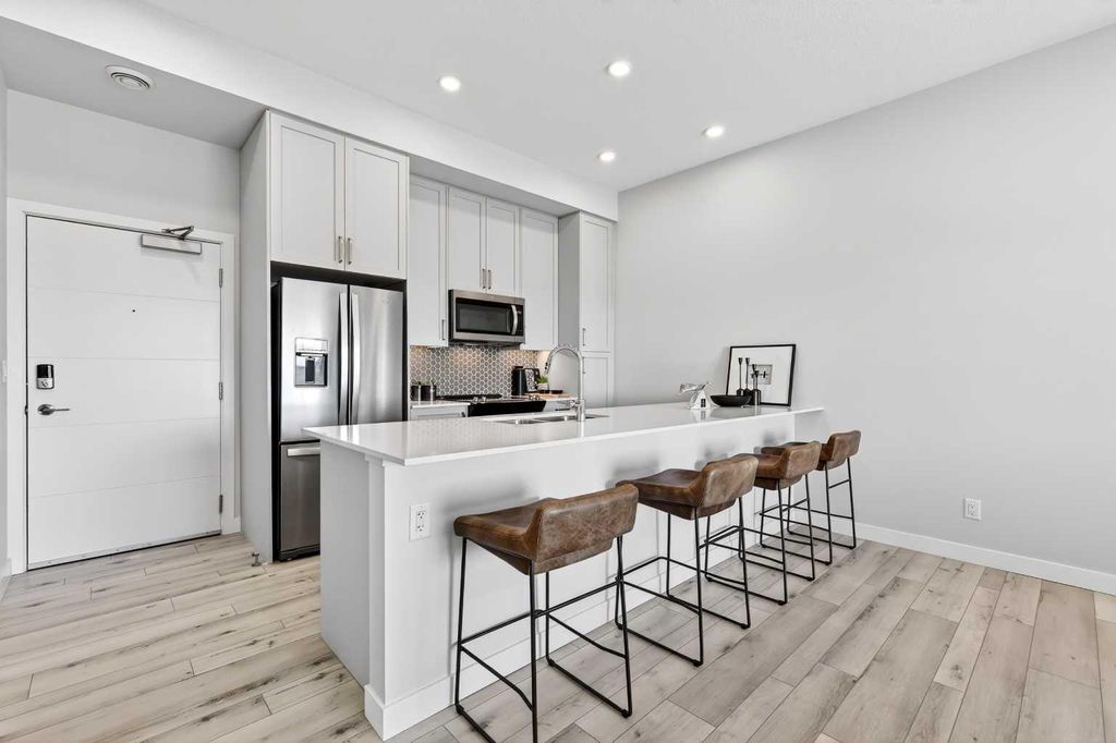 Photo of 255 Les Jardins Park SE #410, Calgary, AB T2C 5W9 (MLS # A2316225)