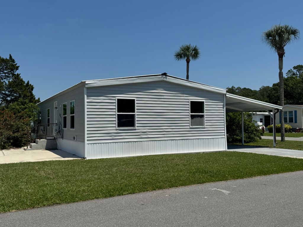 Photo of 124 Whippoorwill Dr, New Smyrna Beach, FL 32168 (MLS # 11775972)