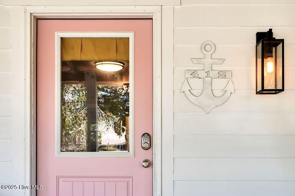 Photo of 412 Womble Street, Oak Island, NC 28465 (MLS # 100538835)