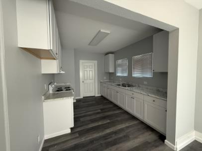Unit C Pic from dining room of kitchen - back door leads to bedroom and bathroom