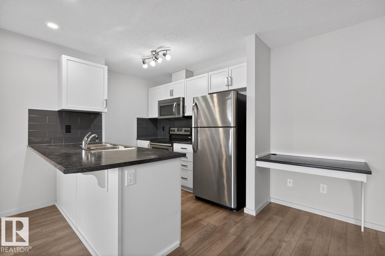 #426 390 WINDERMERE RD NW