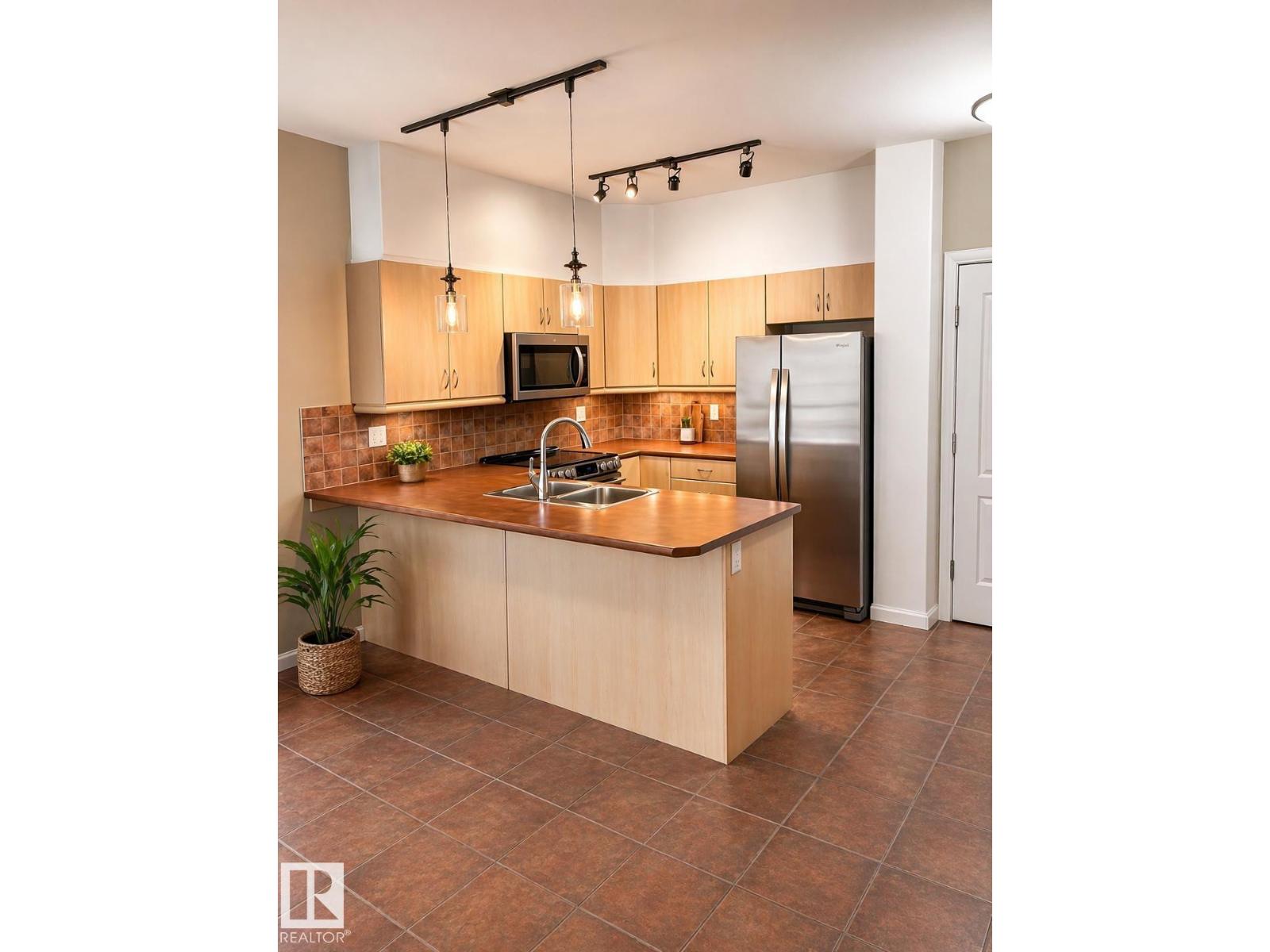 #310 1406 HODGSON WY NW