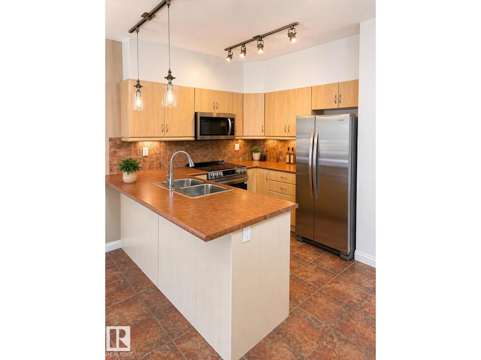 #310 1406 HODGSON WY NW