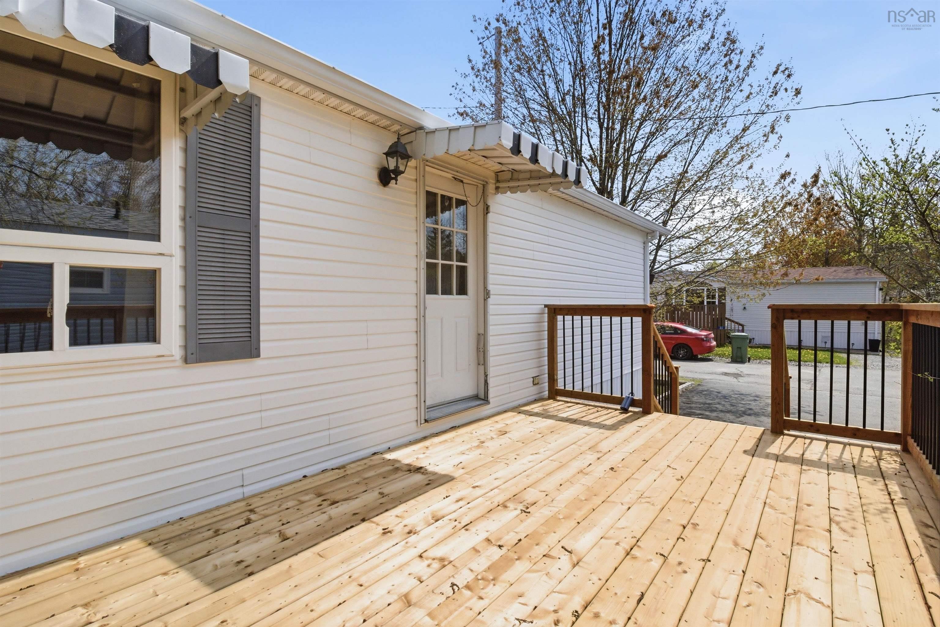 Expansive wood deck with dark wood railings and black balusters