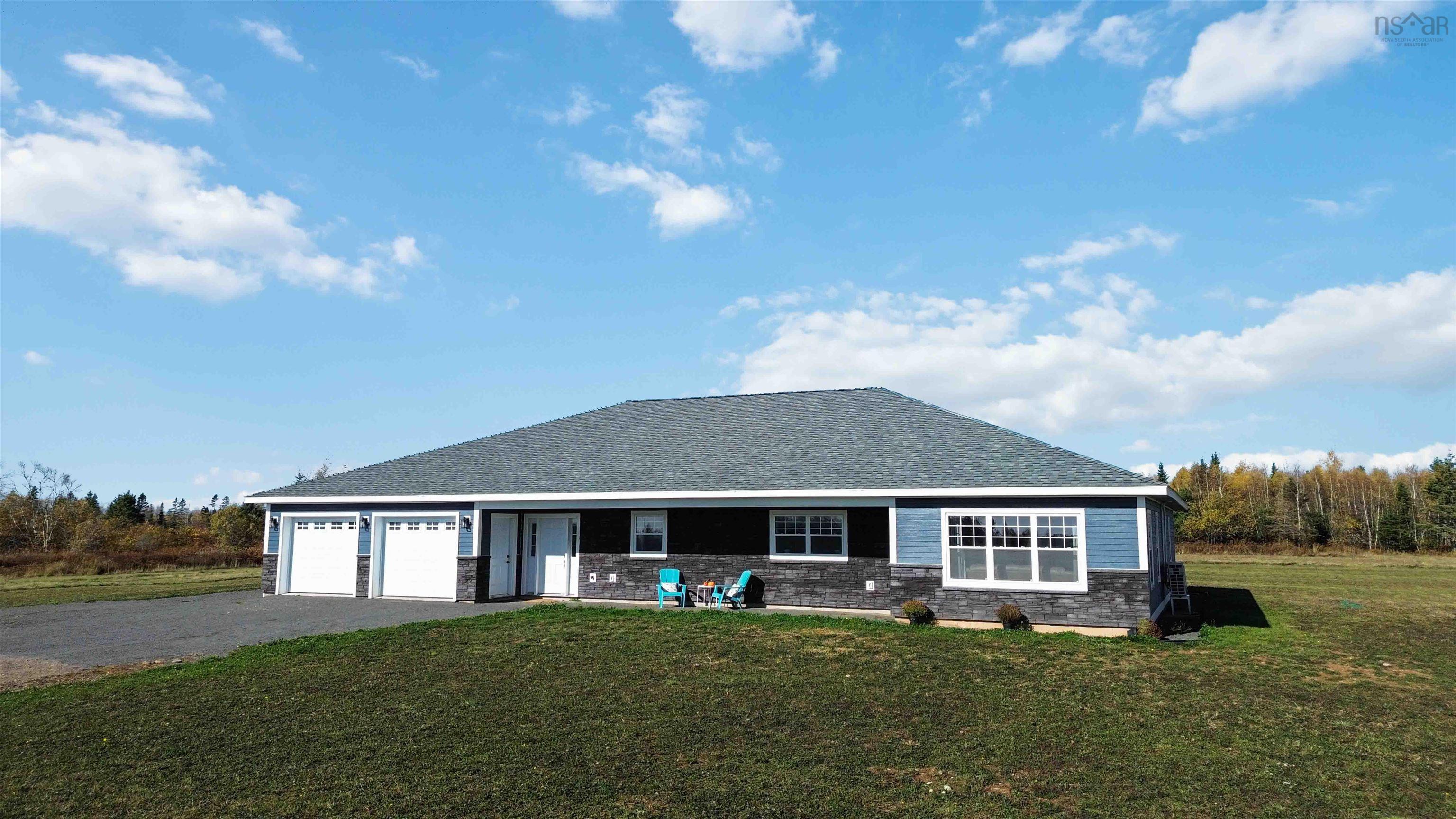 The property features a dark gray shingle roof, blue siding, and white trim
