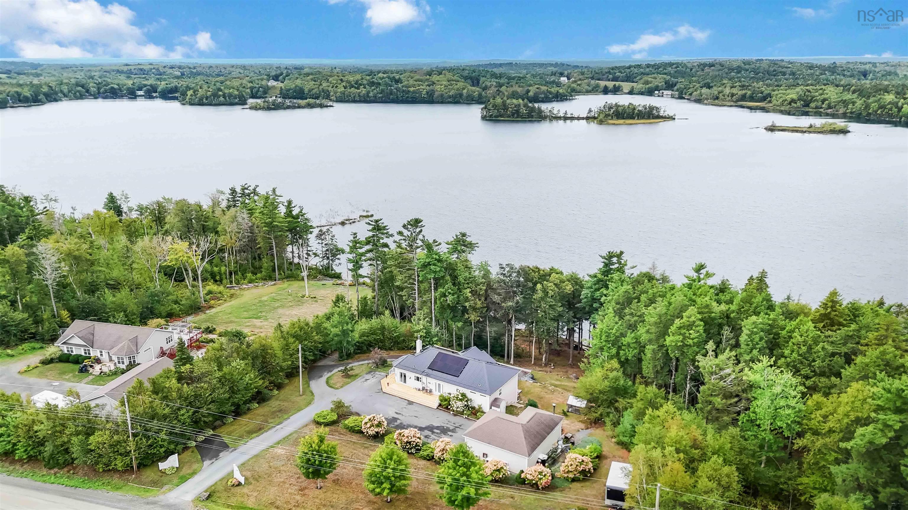 Bird's eye view of a heavily wooded area and a nearby body of water