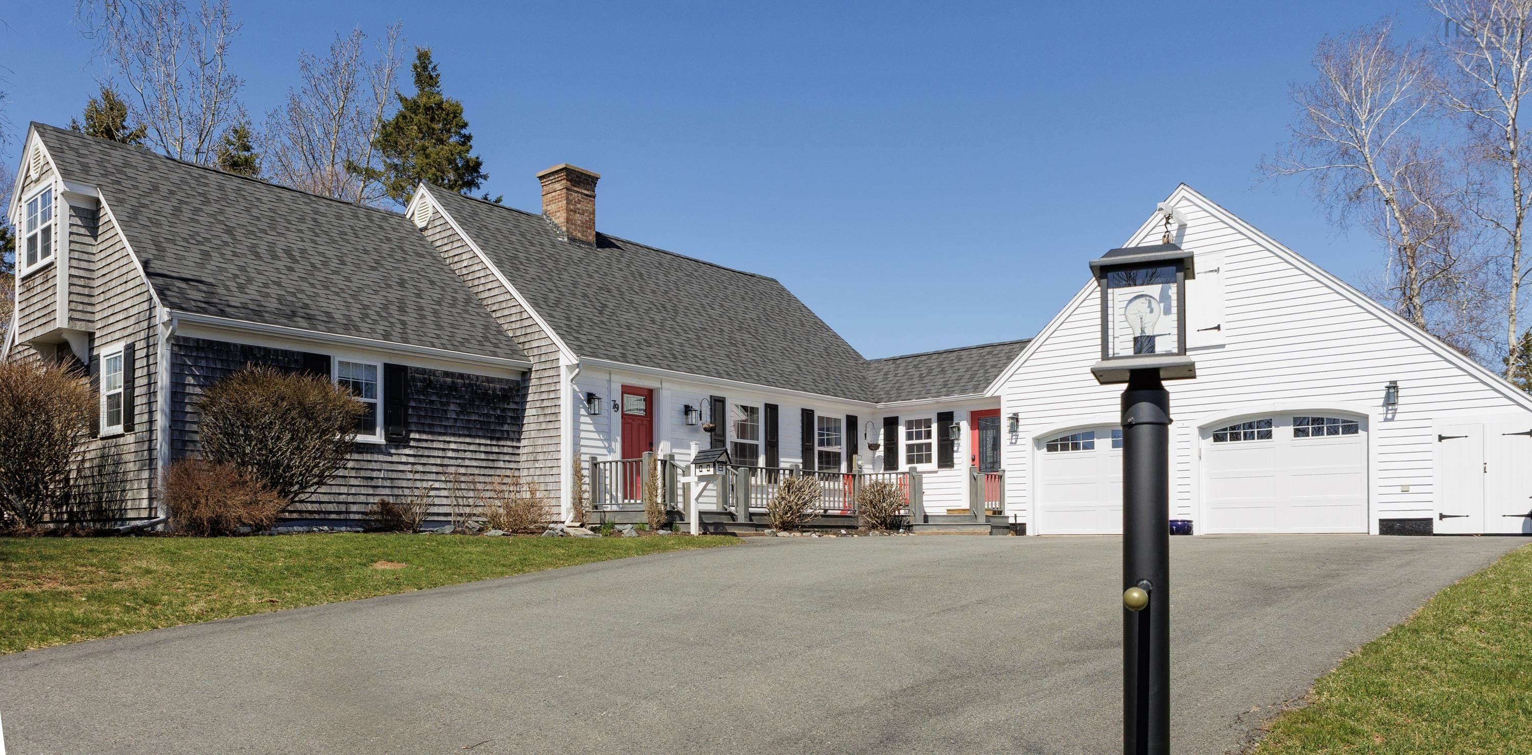 White horizontal siding exterior with black shutters and contrasting red entry doors