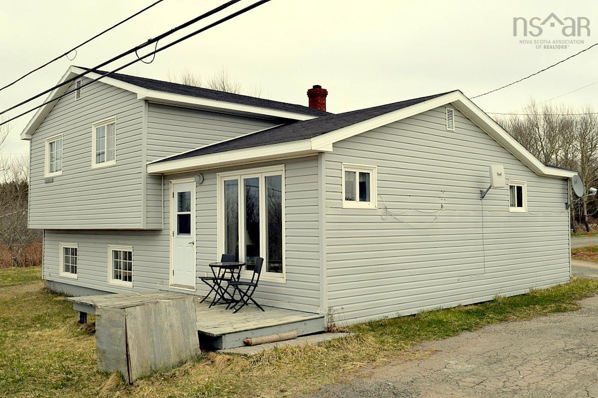 Two-story residence featuring light gray horizontal siding and white trim