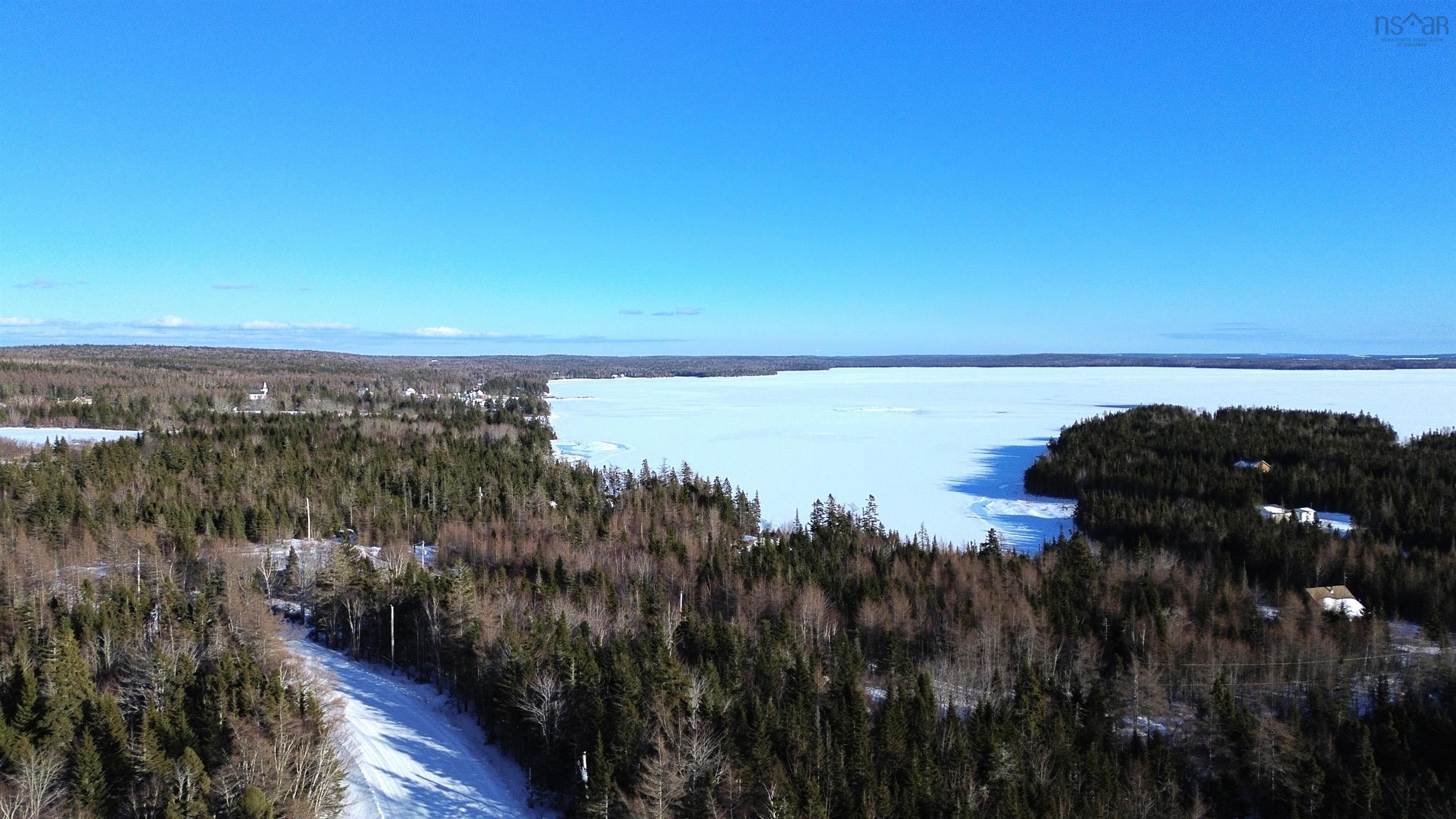 Birds eye view of property featuring a water view and a forest view