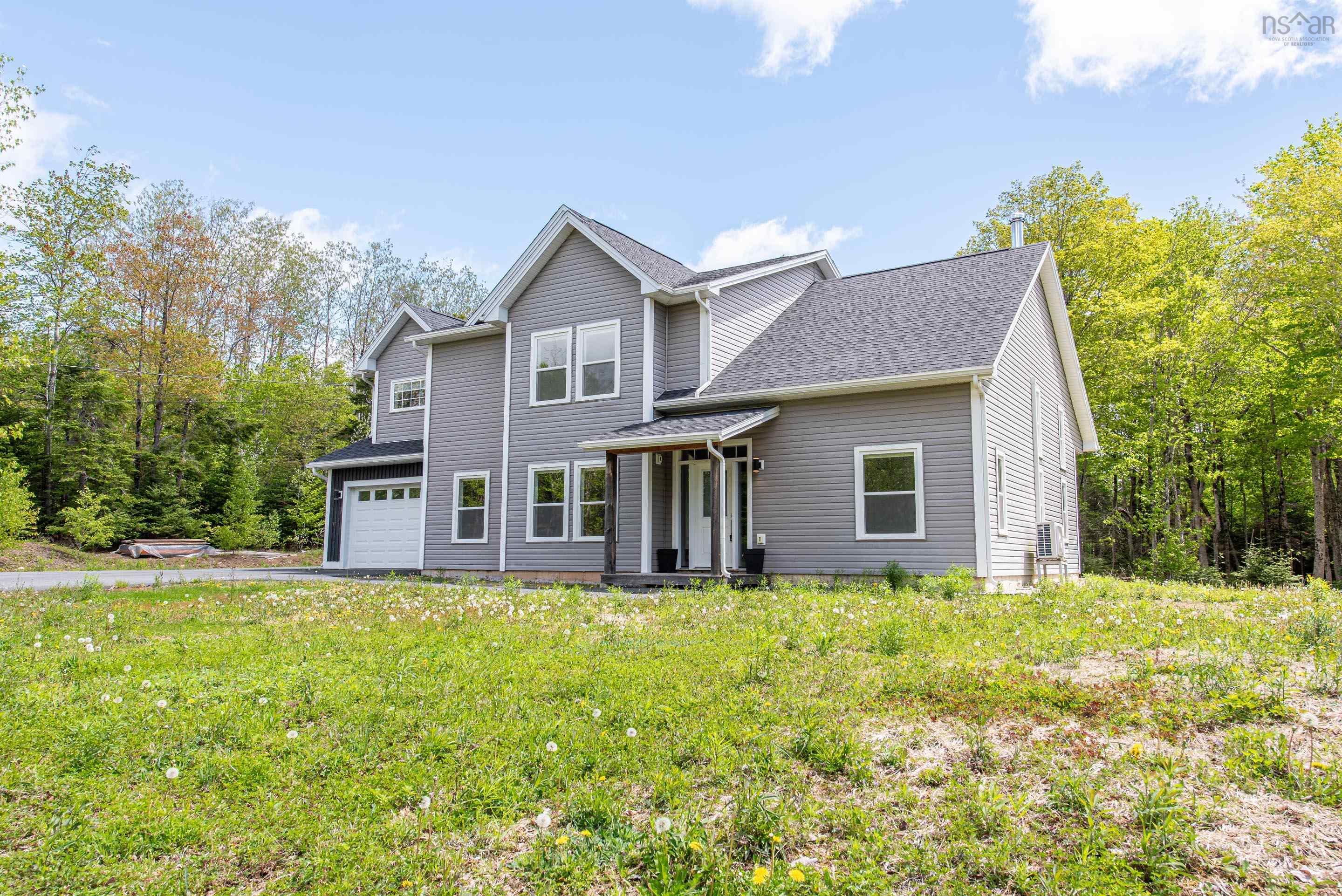 Contemporary two-story residence featuring gray siding, a prominent attached single-car garage, and a covered entry porch