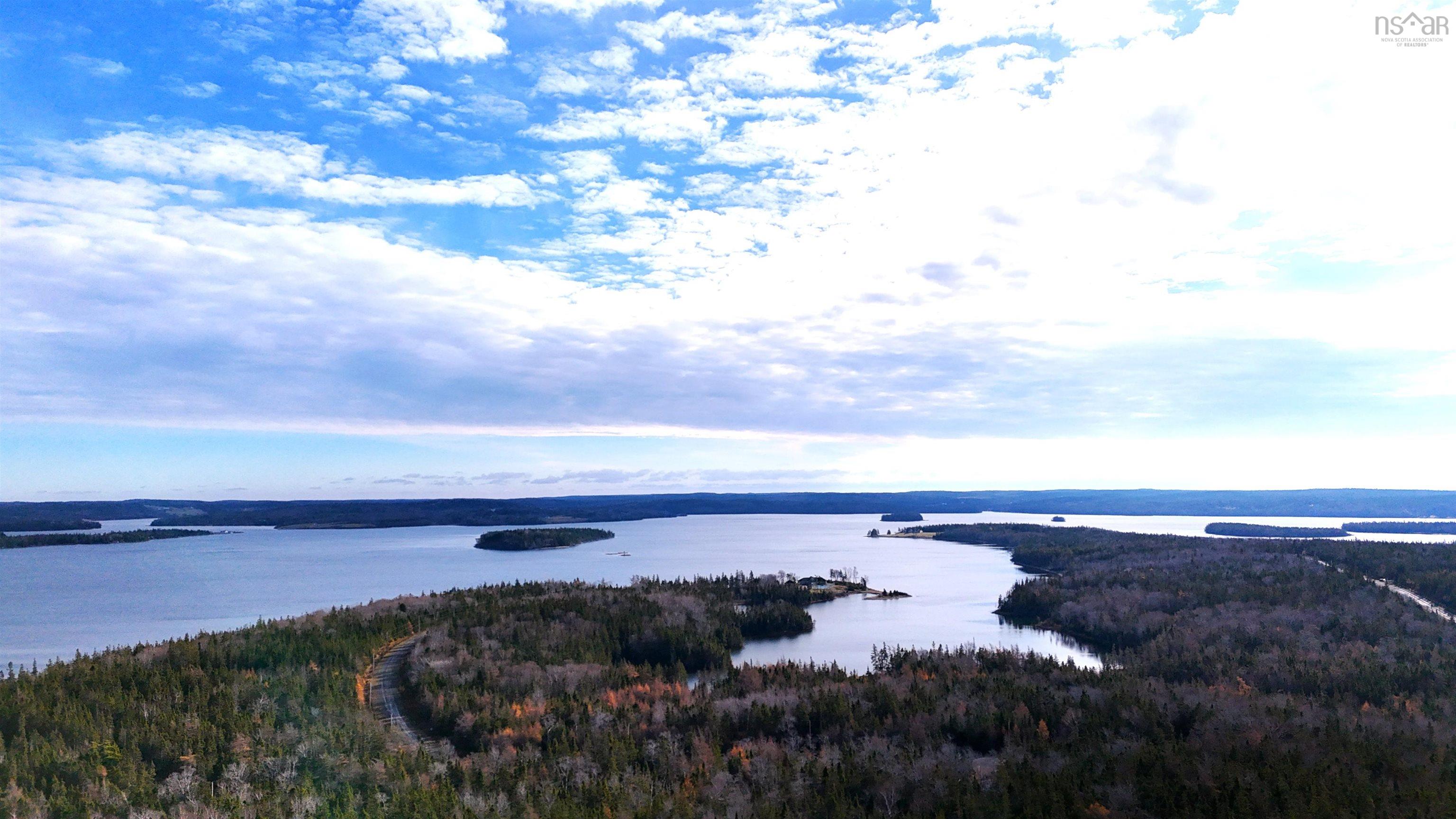 Water view with a heavily wooded area