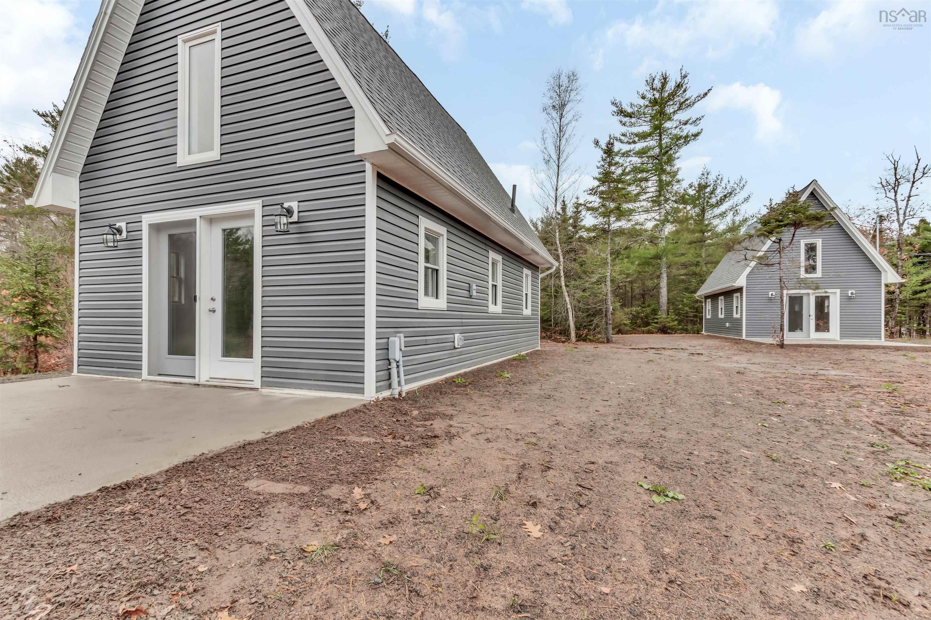 View of home's exterior with french doors, roof with shingles, and a patio area