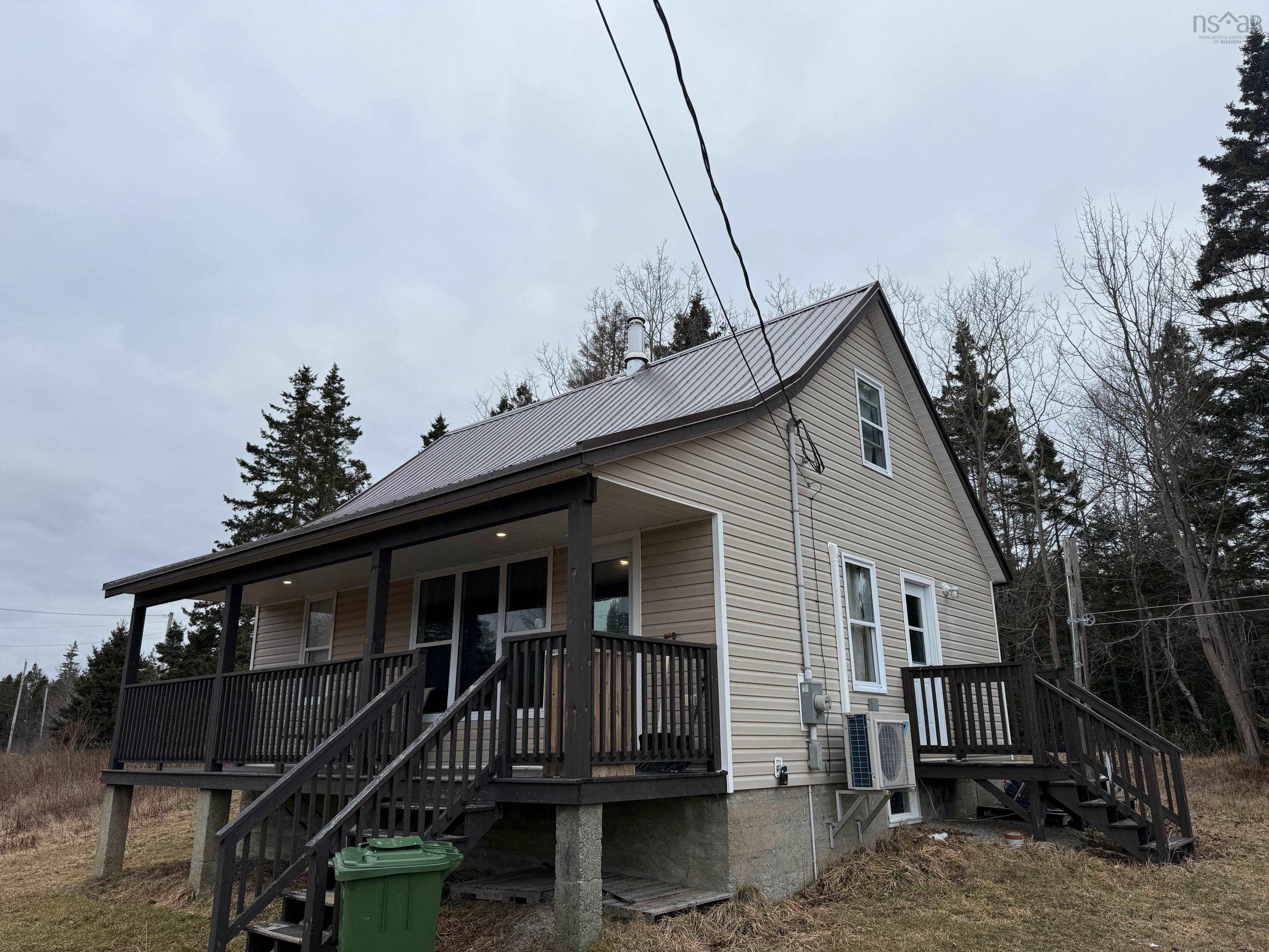 View of front of home with a metal roof and a porch