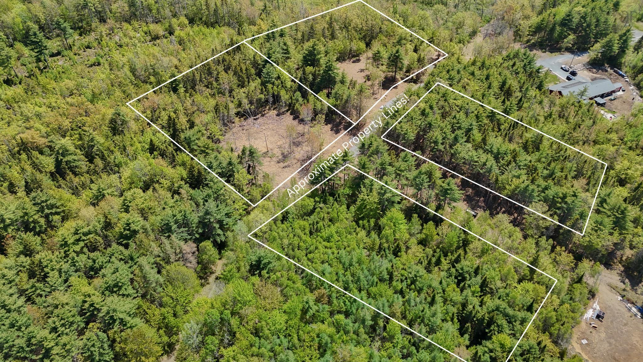 Aerial overview of property's location with property boundaries highlighted and a heavily wooded area